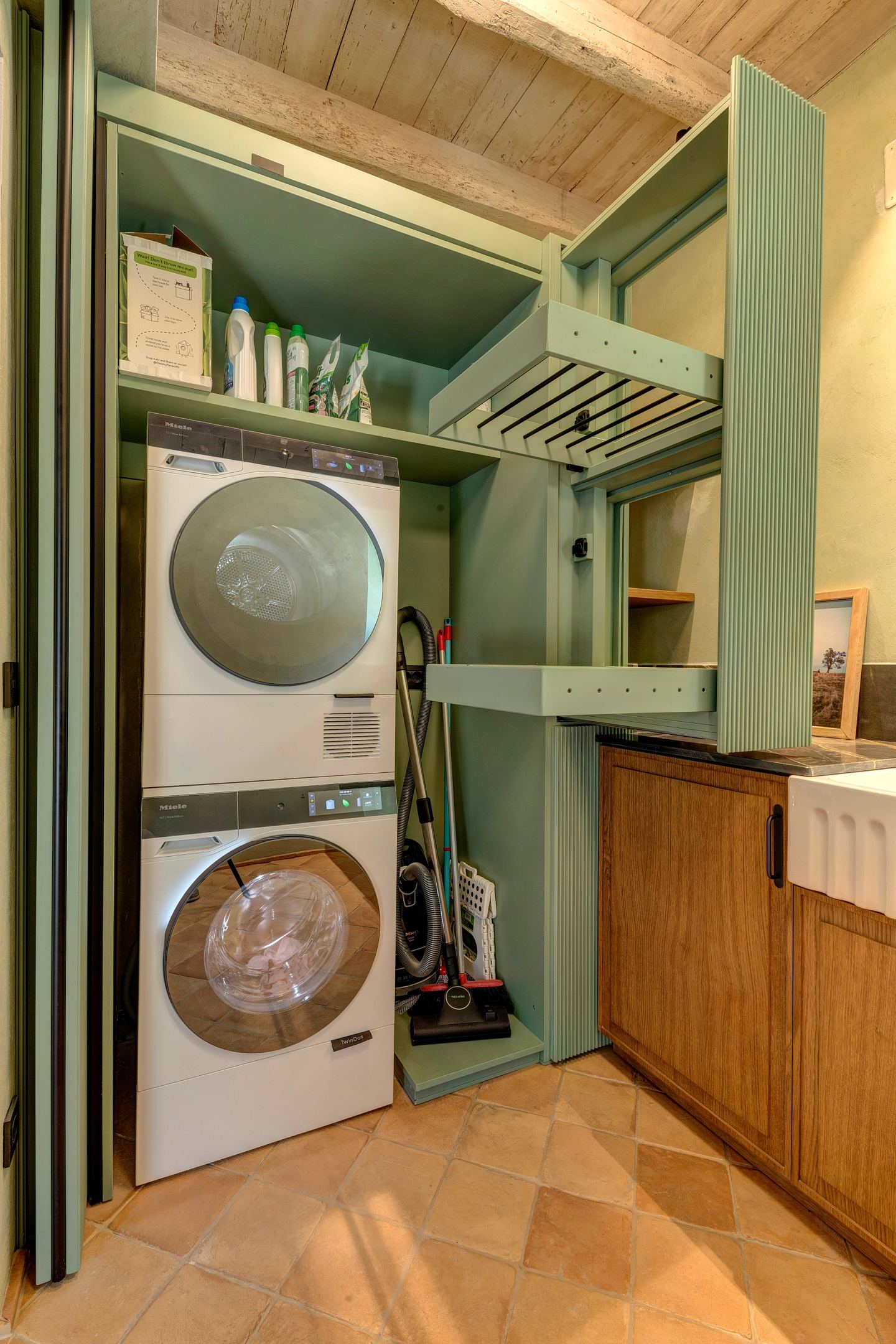 Washer and dryer inside the green cupboard