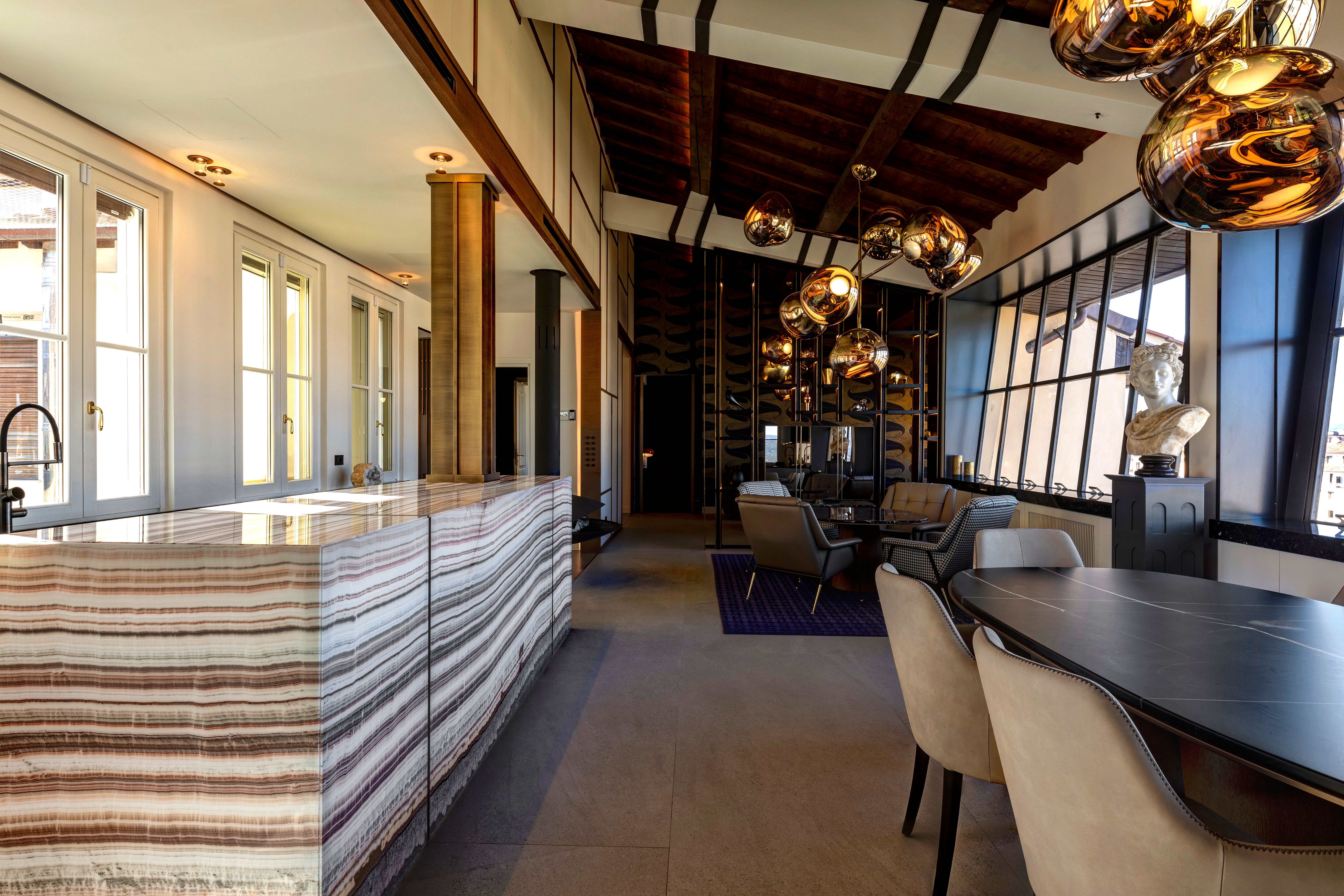 The onyx counter running the length of the room toward the dining table