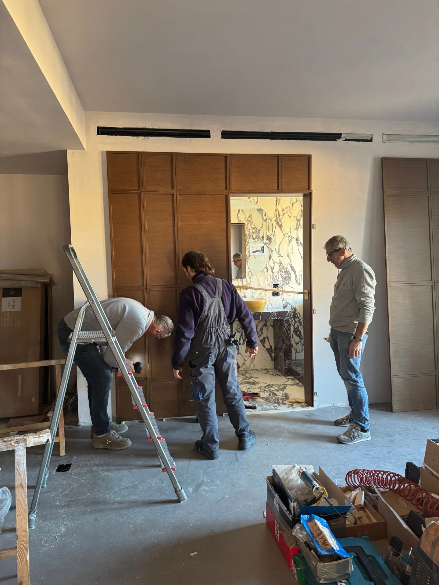Fitting the office panelling, the marble bathroom beyond the doorway