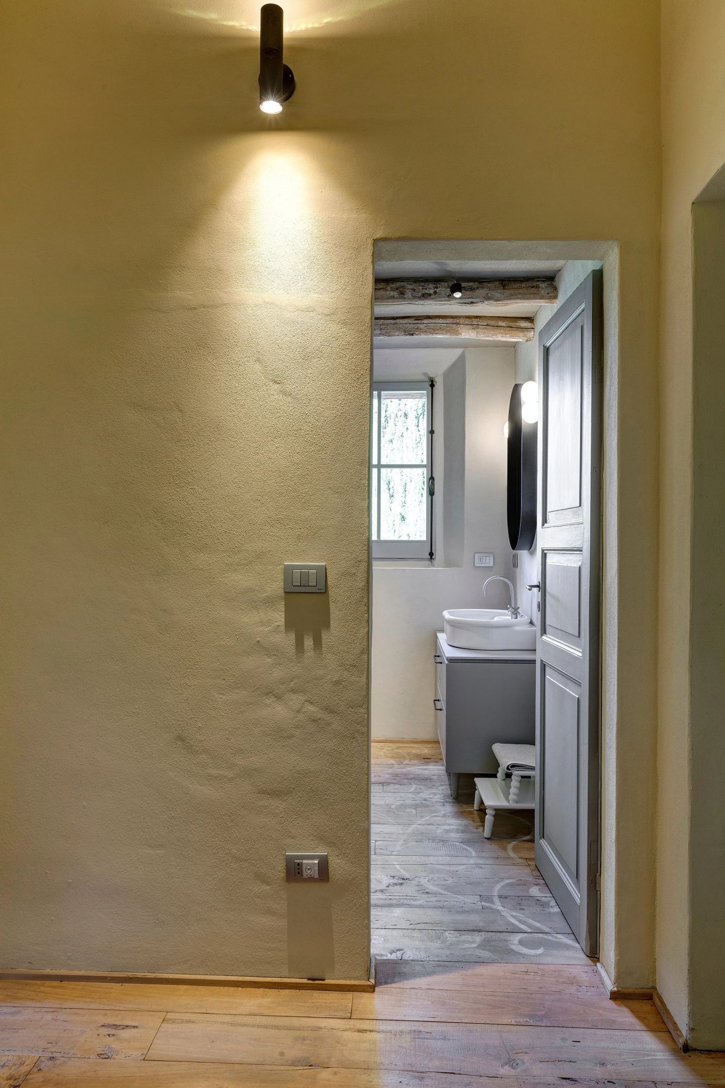 The corridor's end, a bathroom door ajar