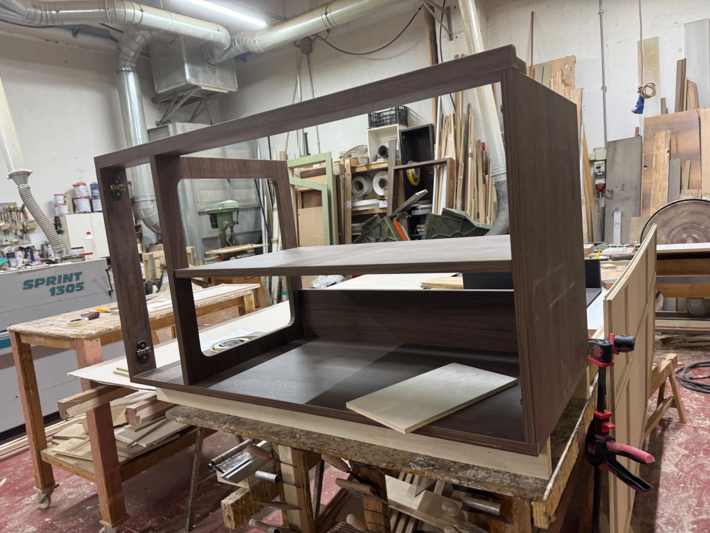 A dark wood frame assembled on the bench