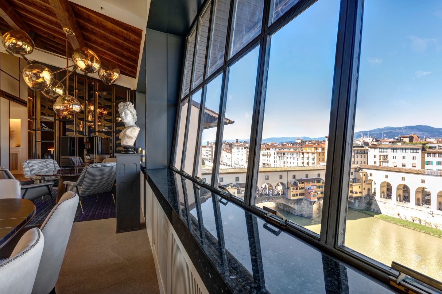 Dining table and window wall, the rooftops of Florence beyond