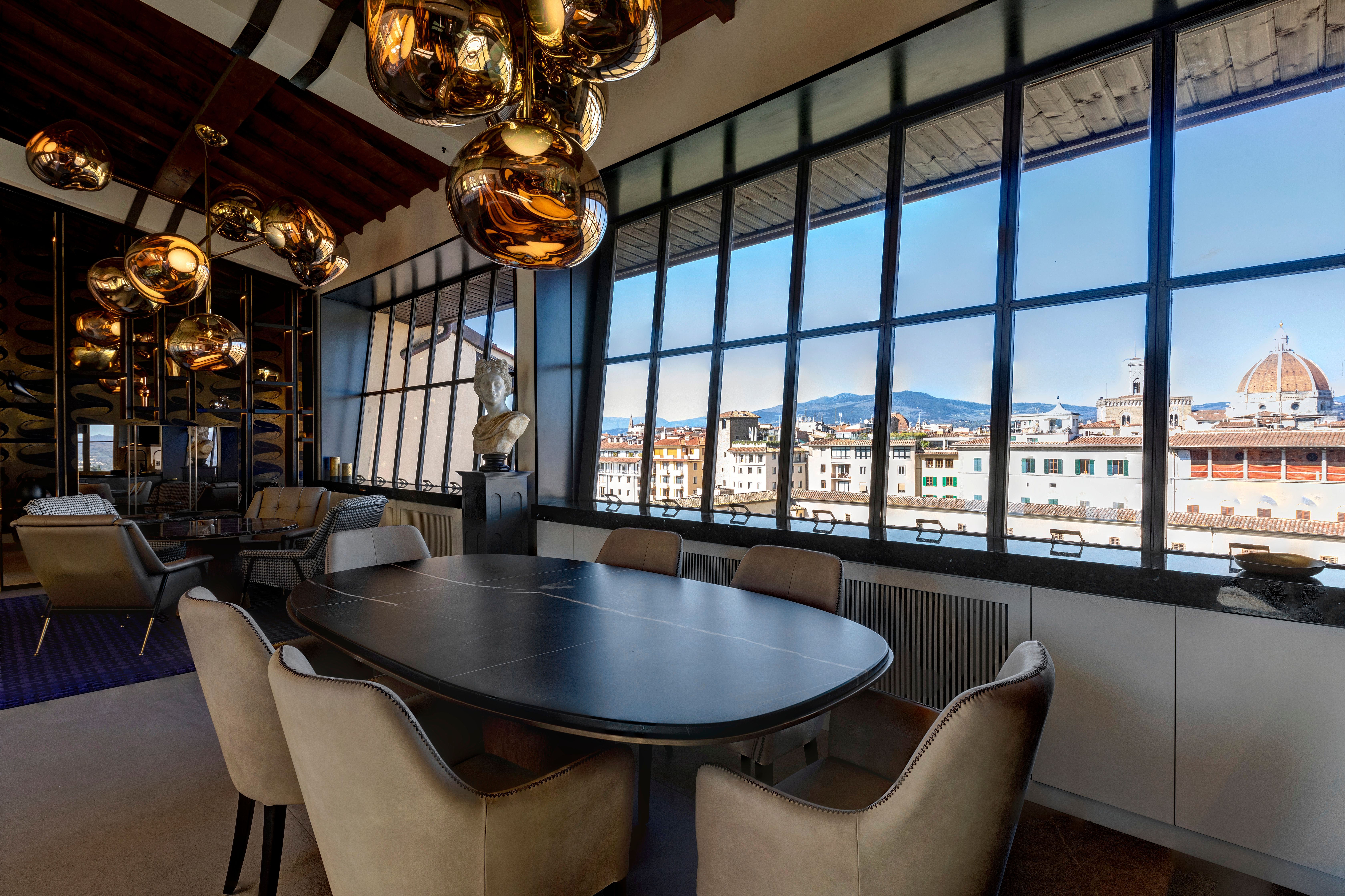 The dining table below the cluster of copper globes