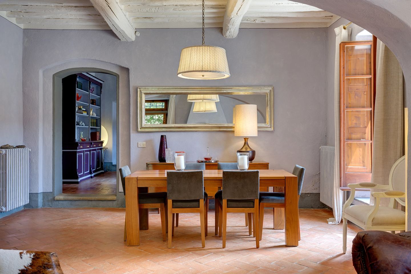 The mirror above the table, shutters open