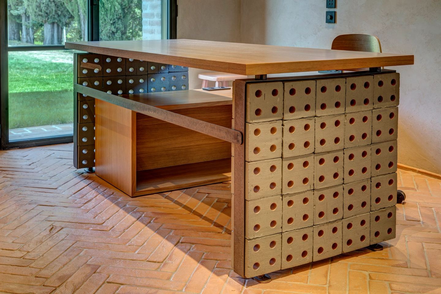 The desk standing on its perforated base