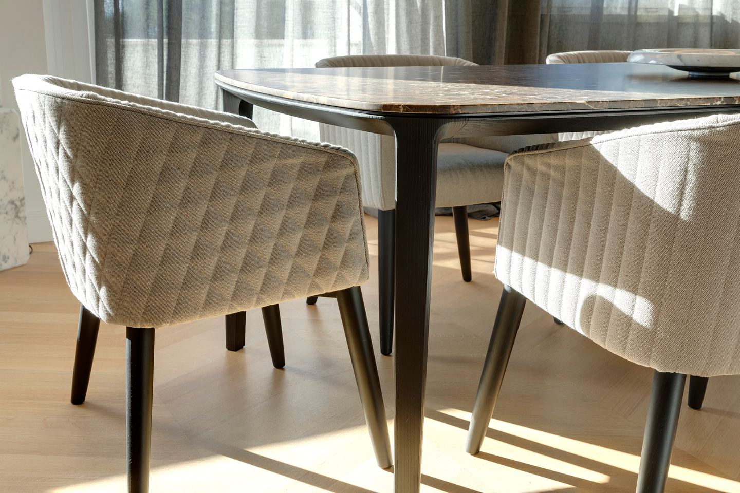 Quilted dining chairs in raking afternoon light