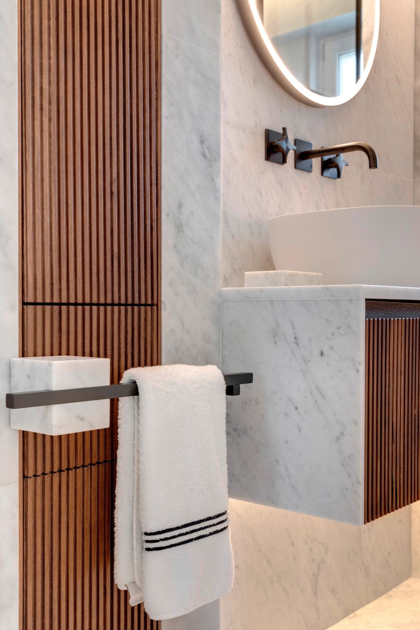 Towel rail on the fluted walnut, the basin beyond