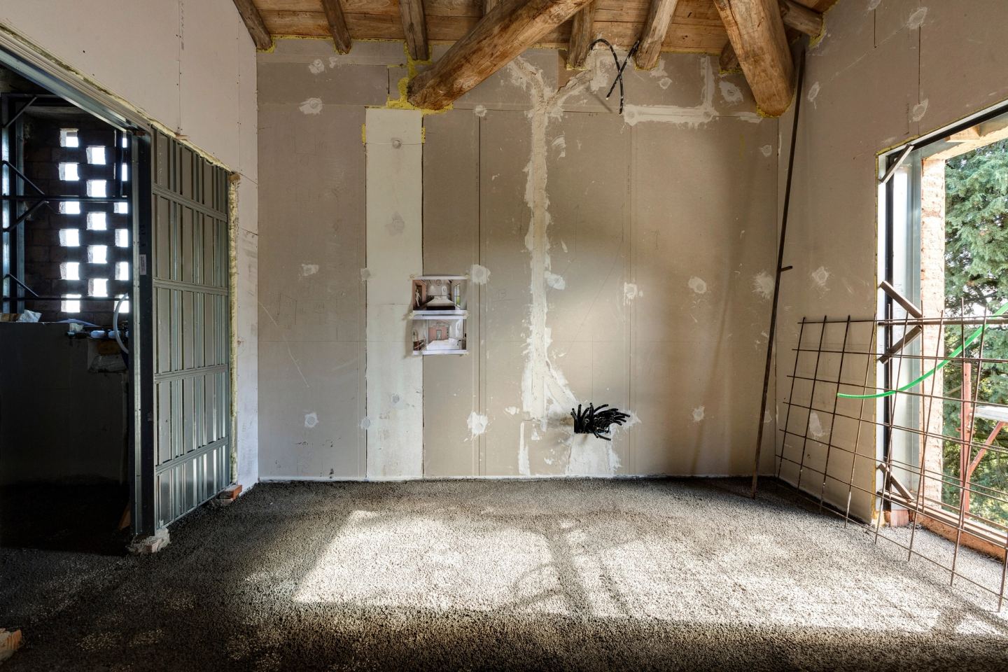 Sun across the bare floor, a perforated brick screen to the left