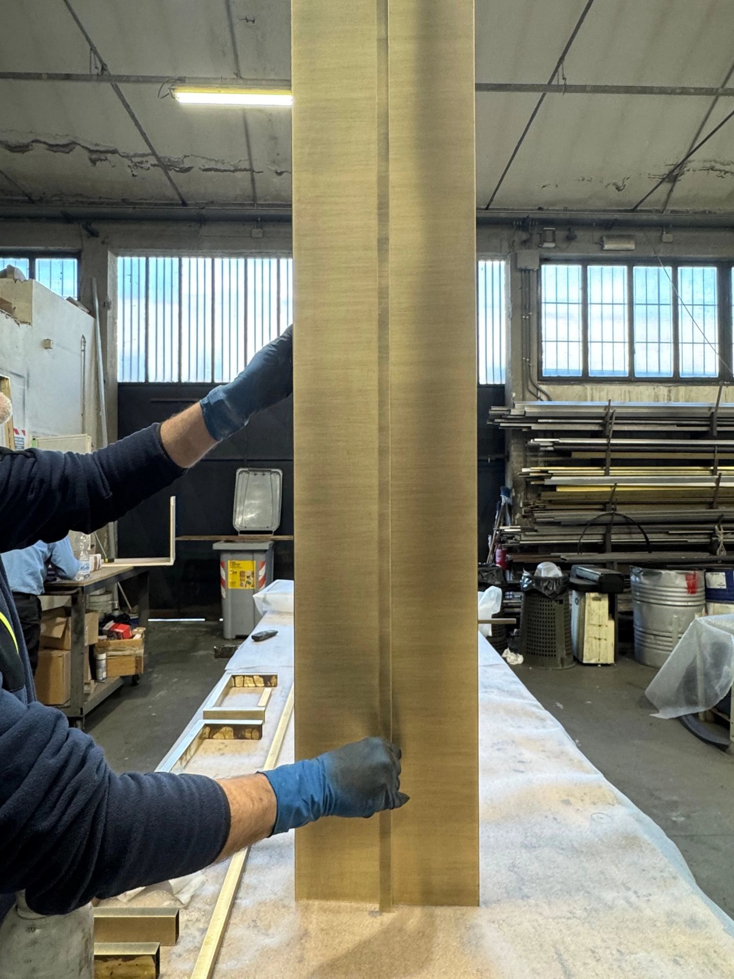 Bronze cladding for a column, checked by hand