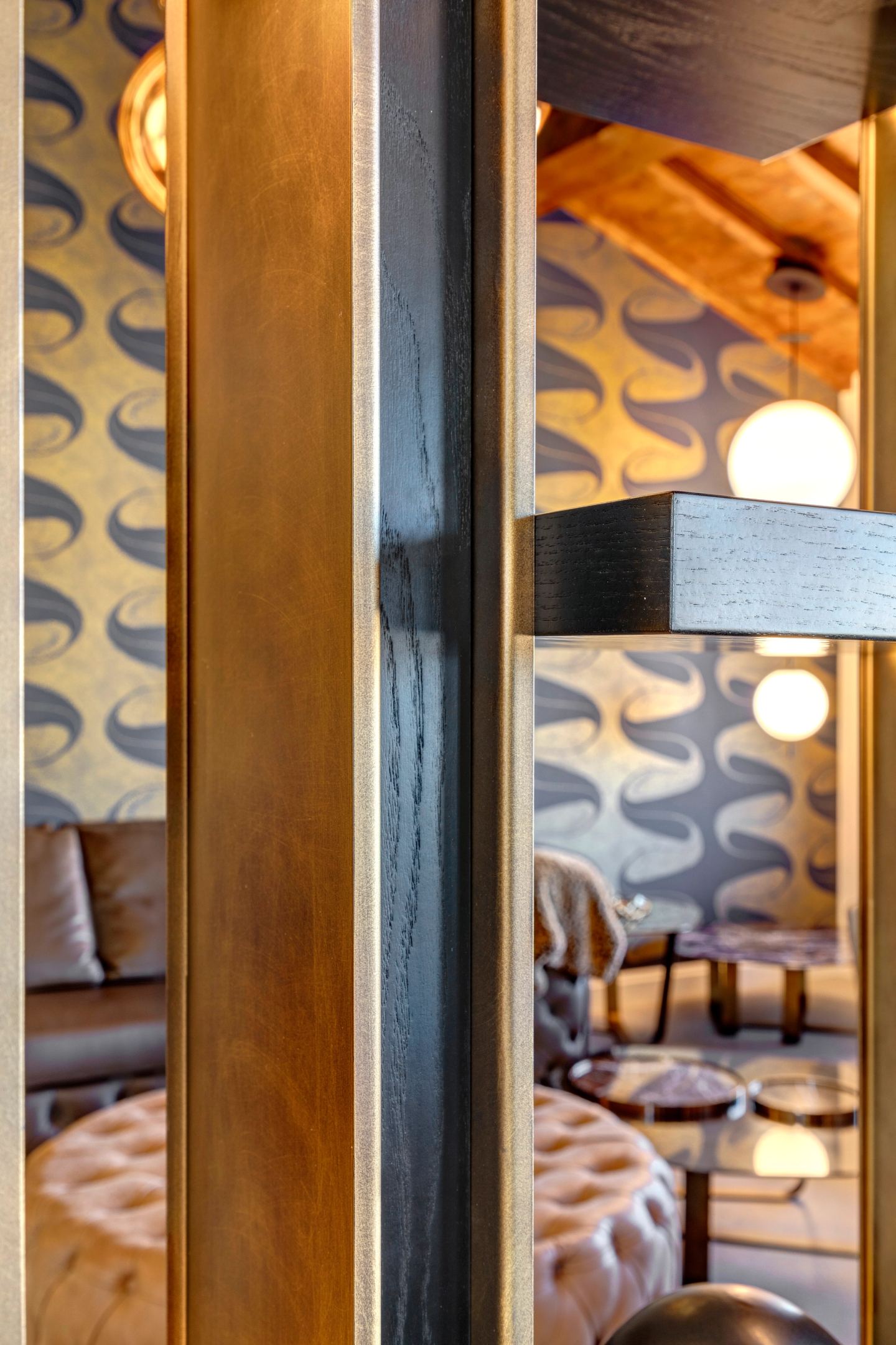 Slats meeting the patterned wall, beams overhead
