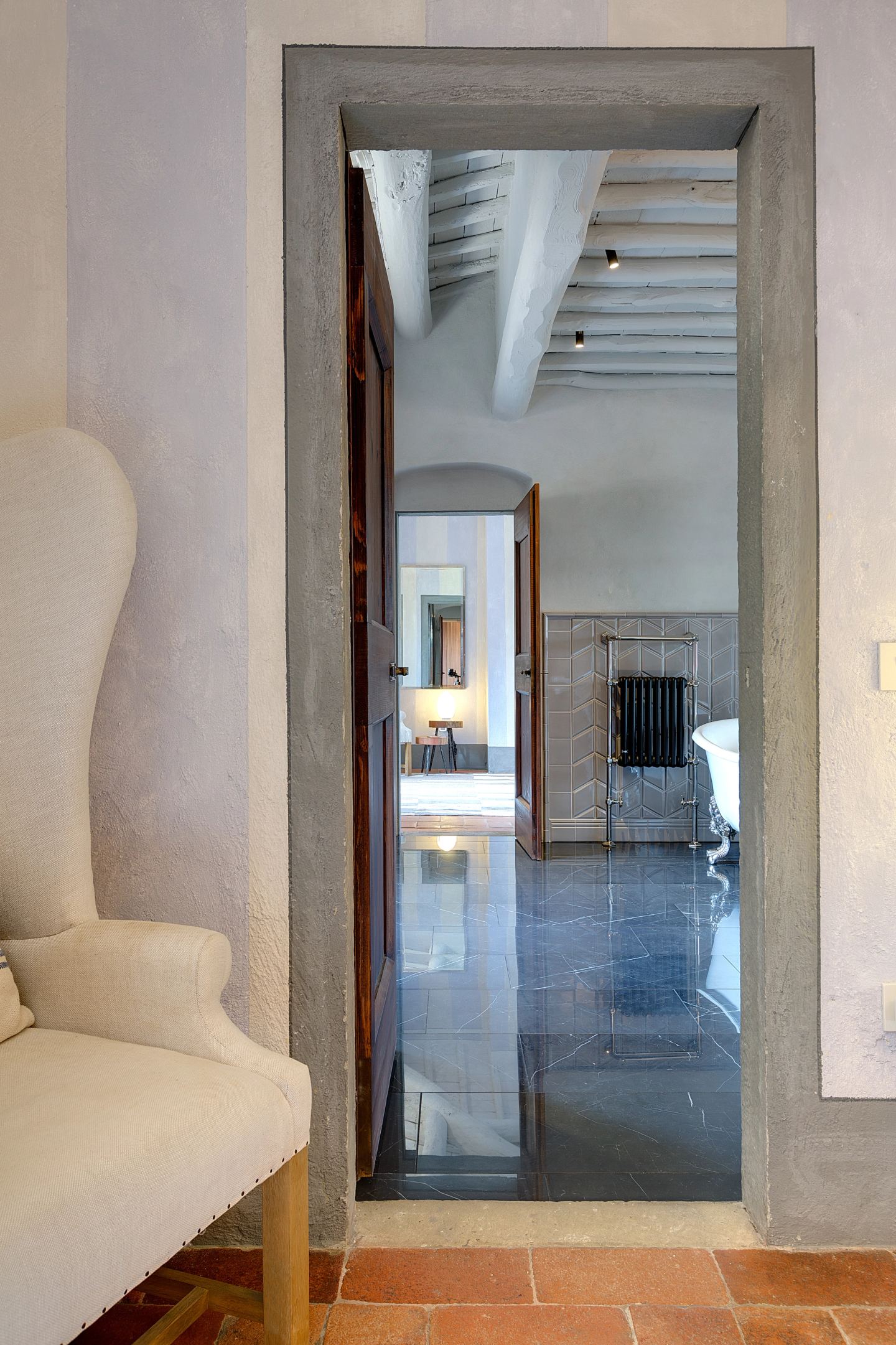 The tall mirror looking through to the bath