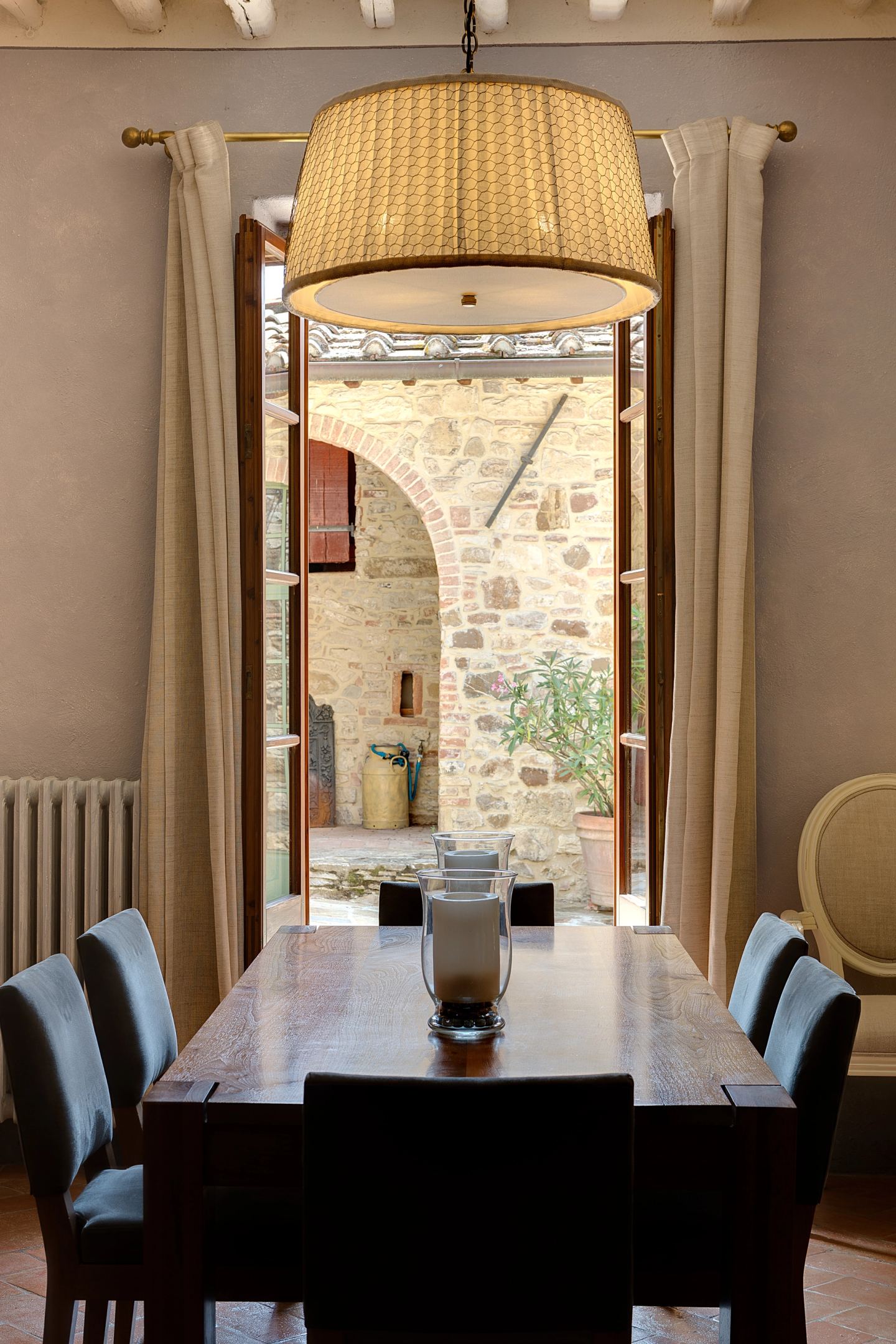 The dark table under its shade, stone wall behind