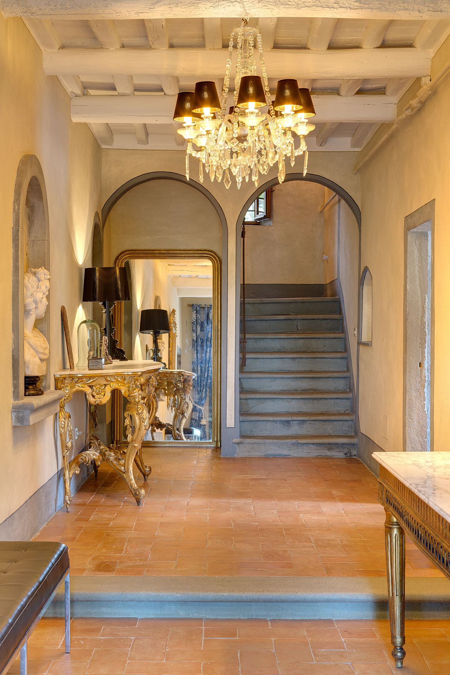 The stair rising at the end of the hall