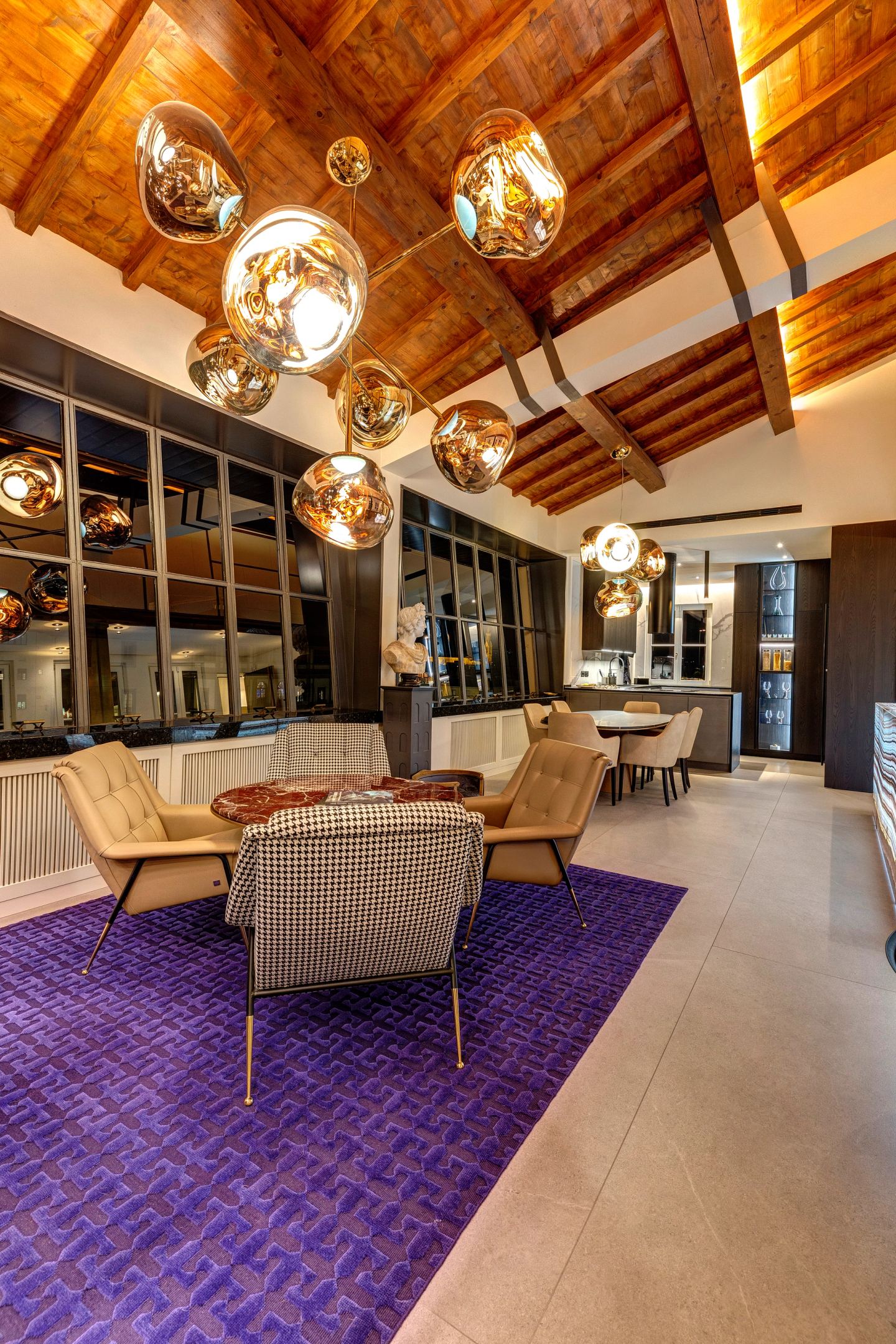 Sofas and low chairs lit from above, evening