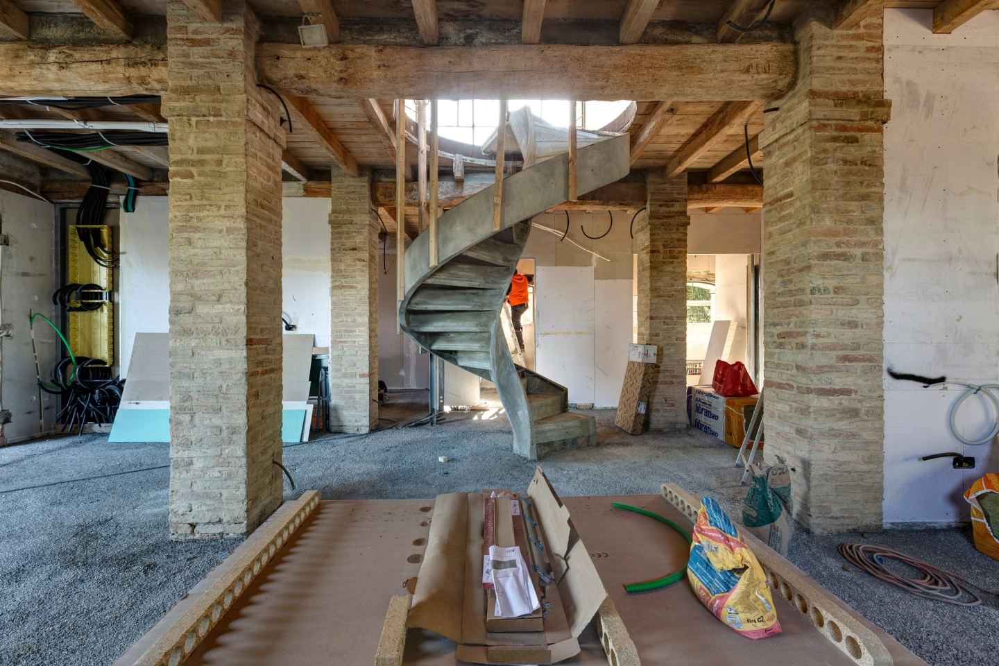 Between the brick piers, the stair rising to the floor above