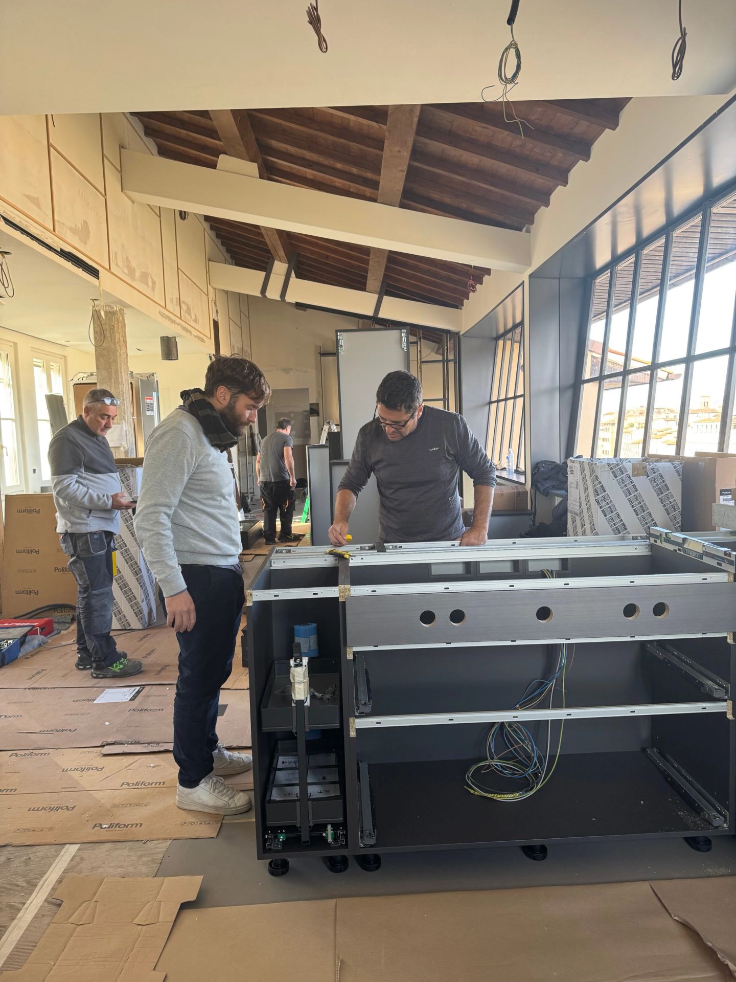 Simone D'Aleo, left, and the team assembling the kitchen island