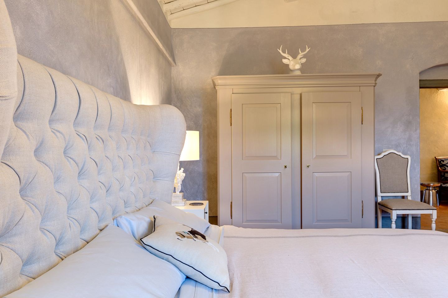 Antlers above the painted wardrobe