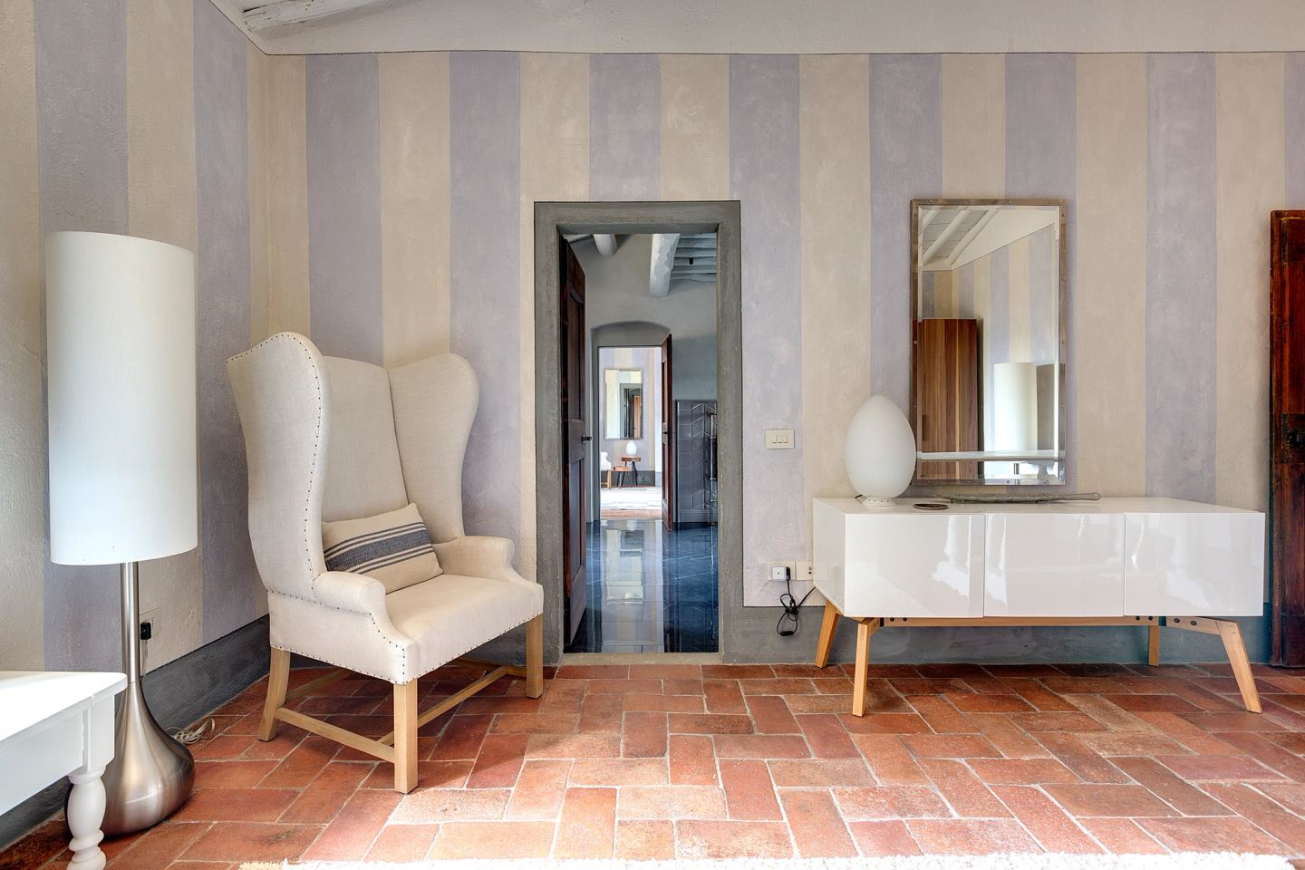A wing chair and the console beside the door