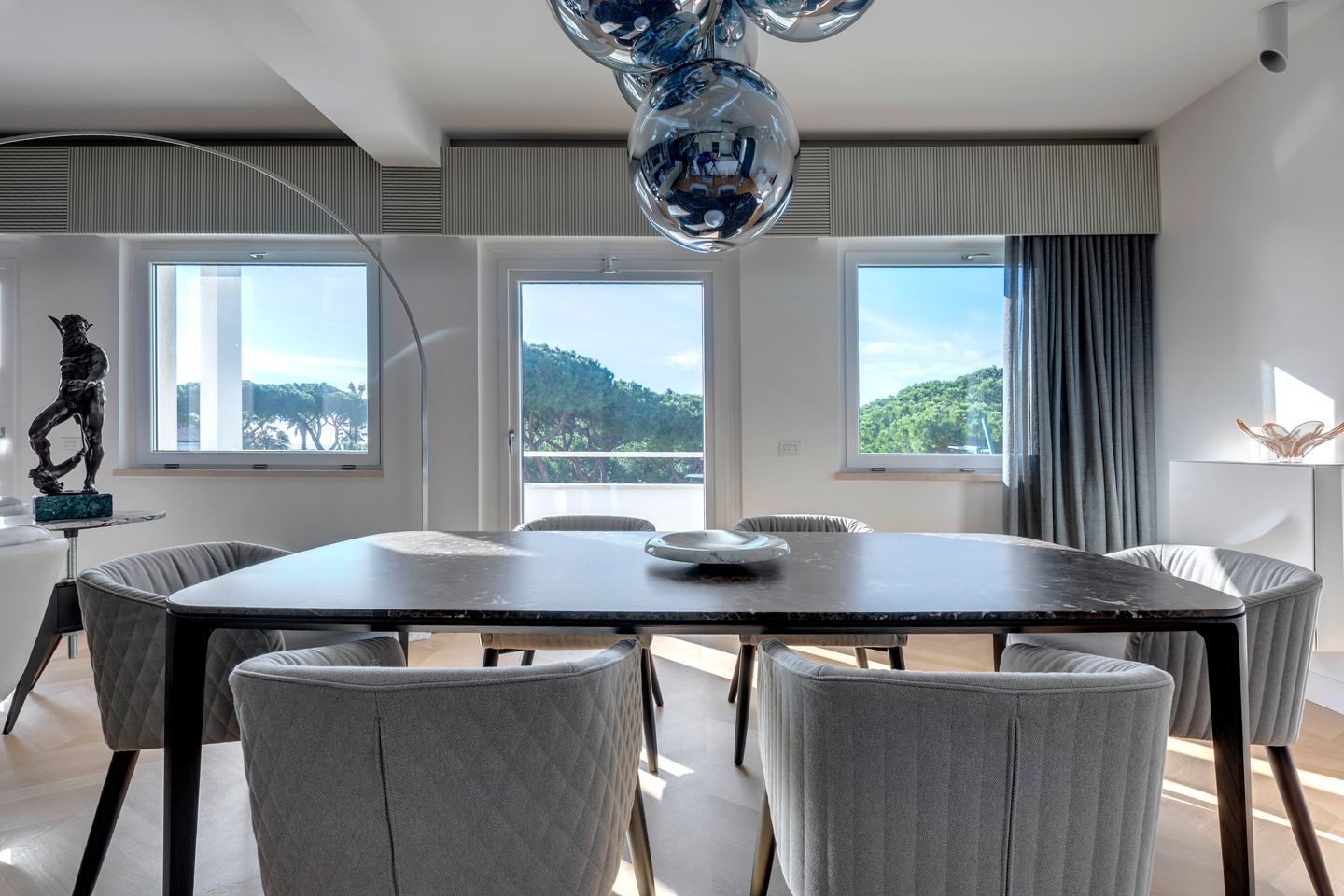 Dining table against the windows, sea light across the room