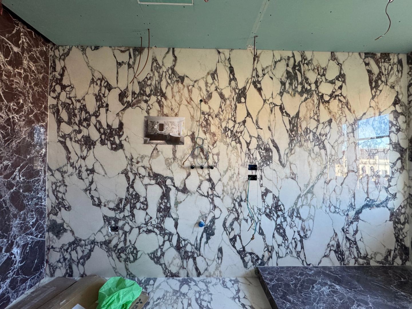 Violet-veined marble covering a bathroom wall