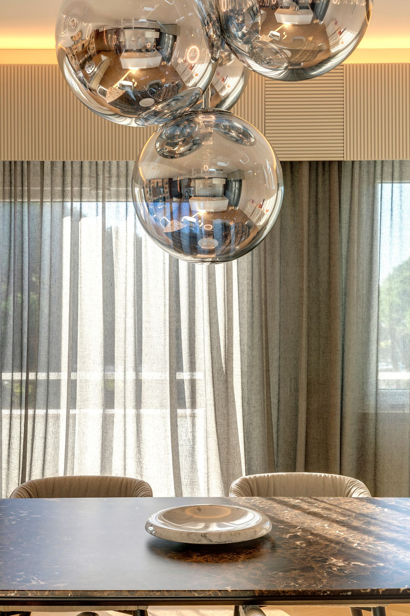 Mirrored globes above the marble table, close