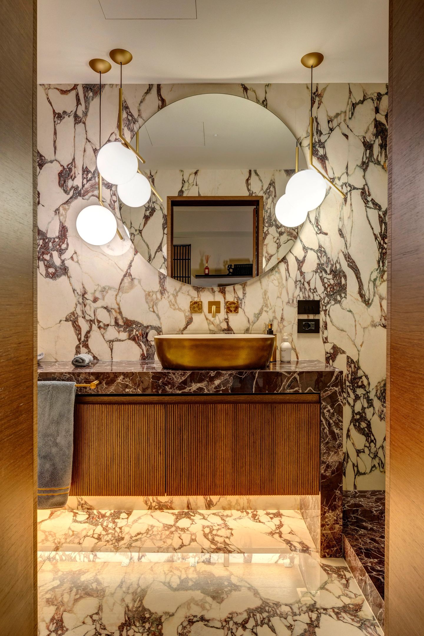 The vanity and mirror at night, the bath lit from below