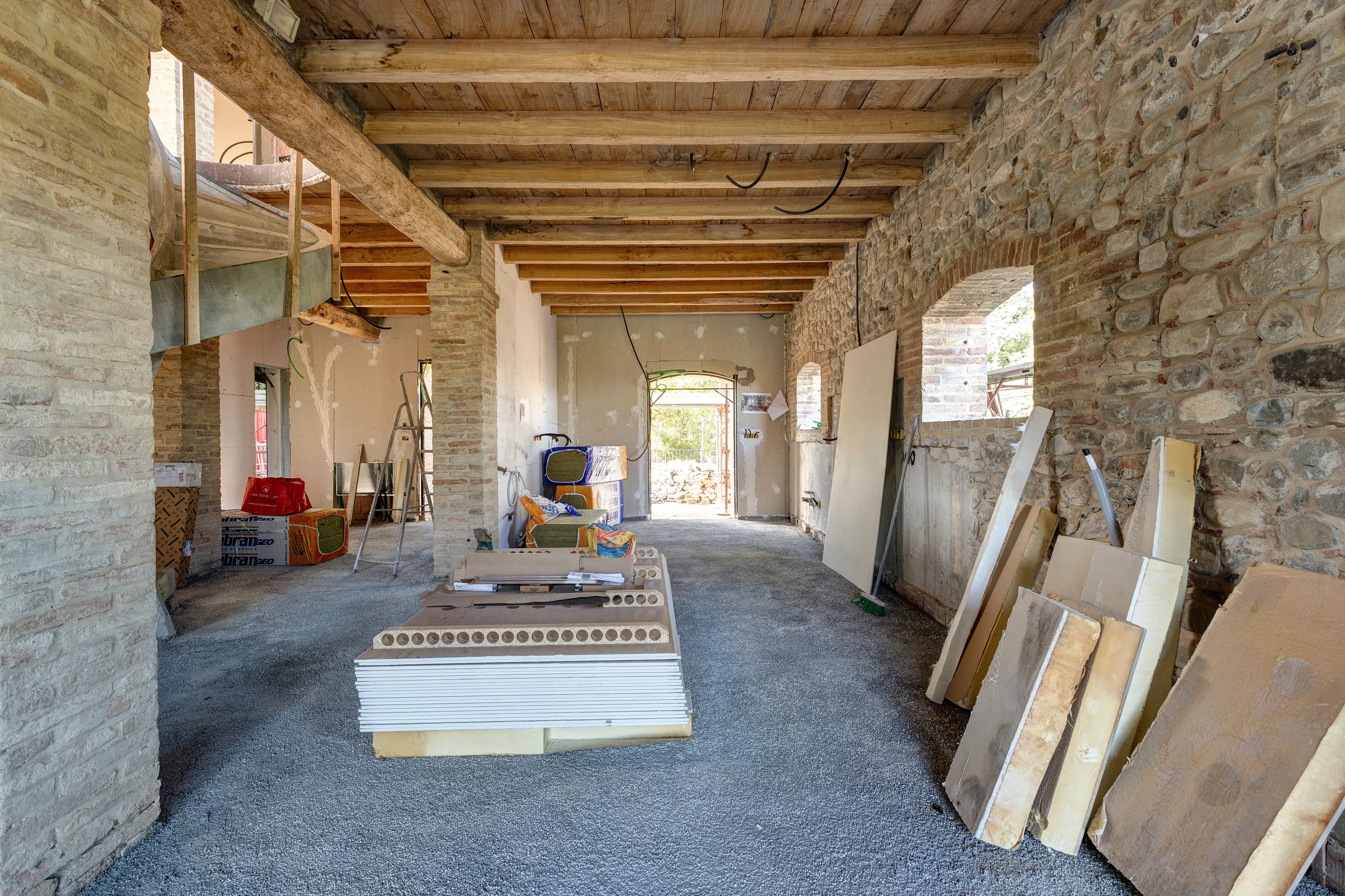 Down the length of the barn floor, boards stacked along the wall