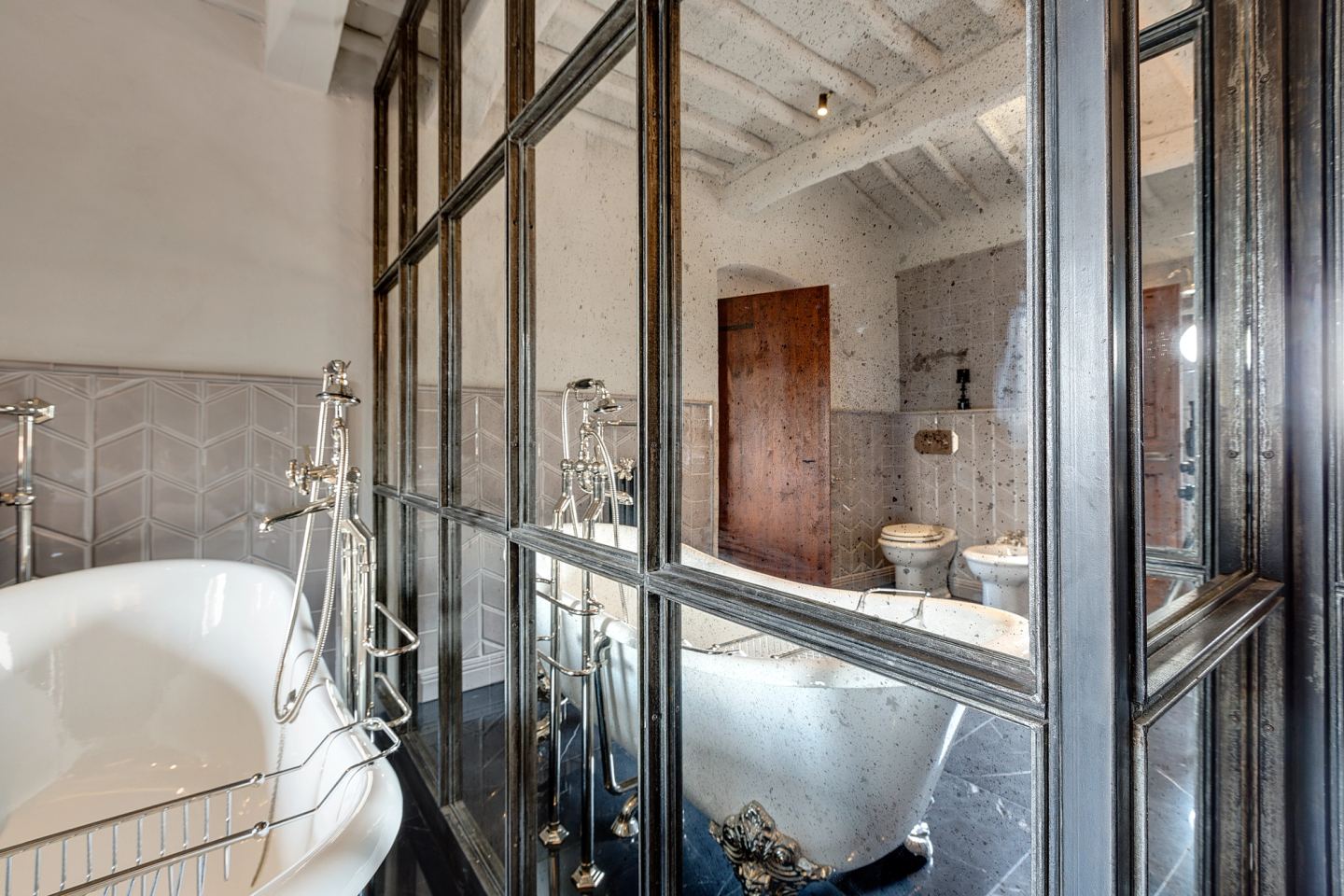 Two bathrooms made one behind the iron frame