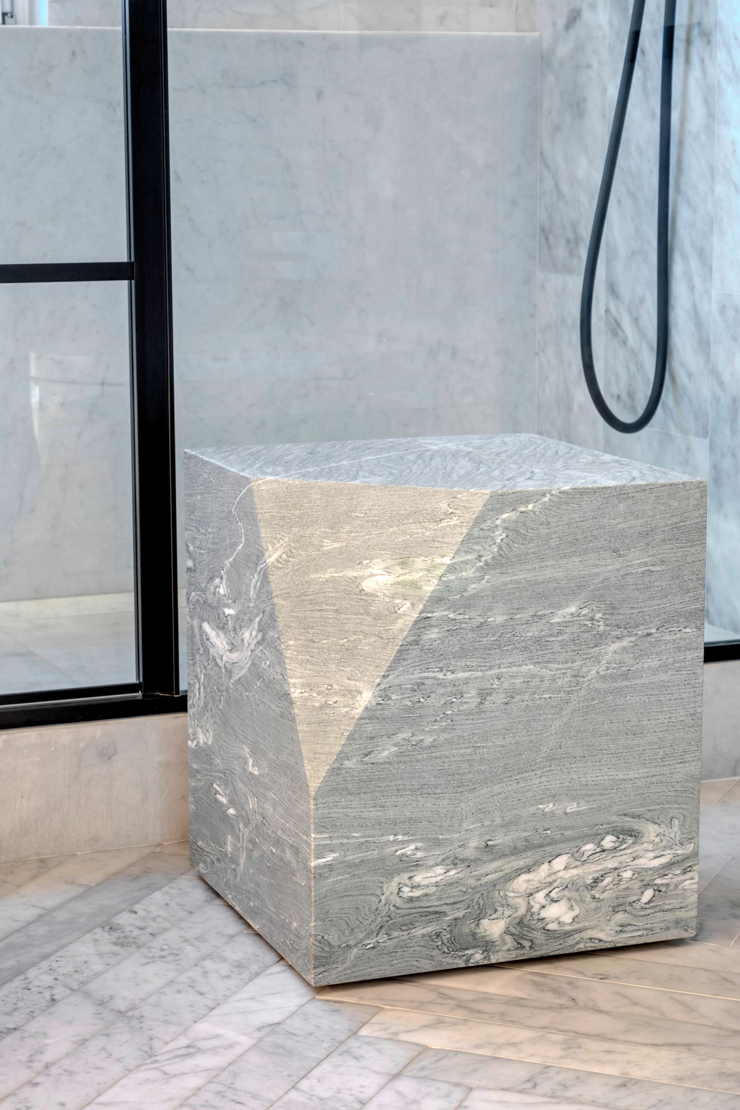 Faceted marble stool in the shower