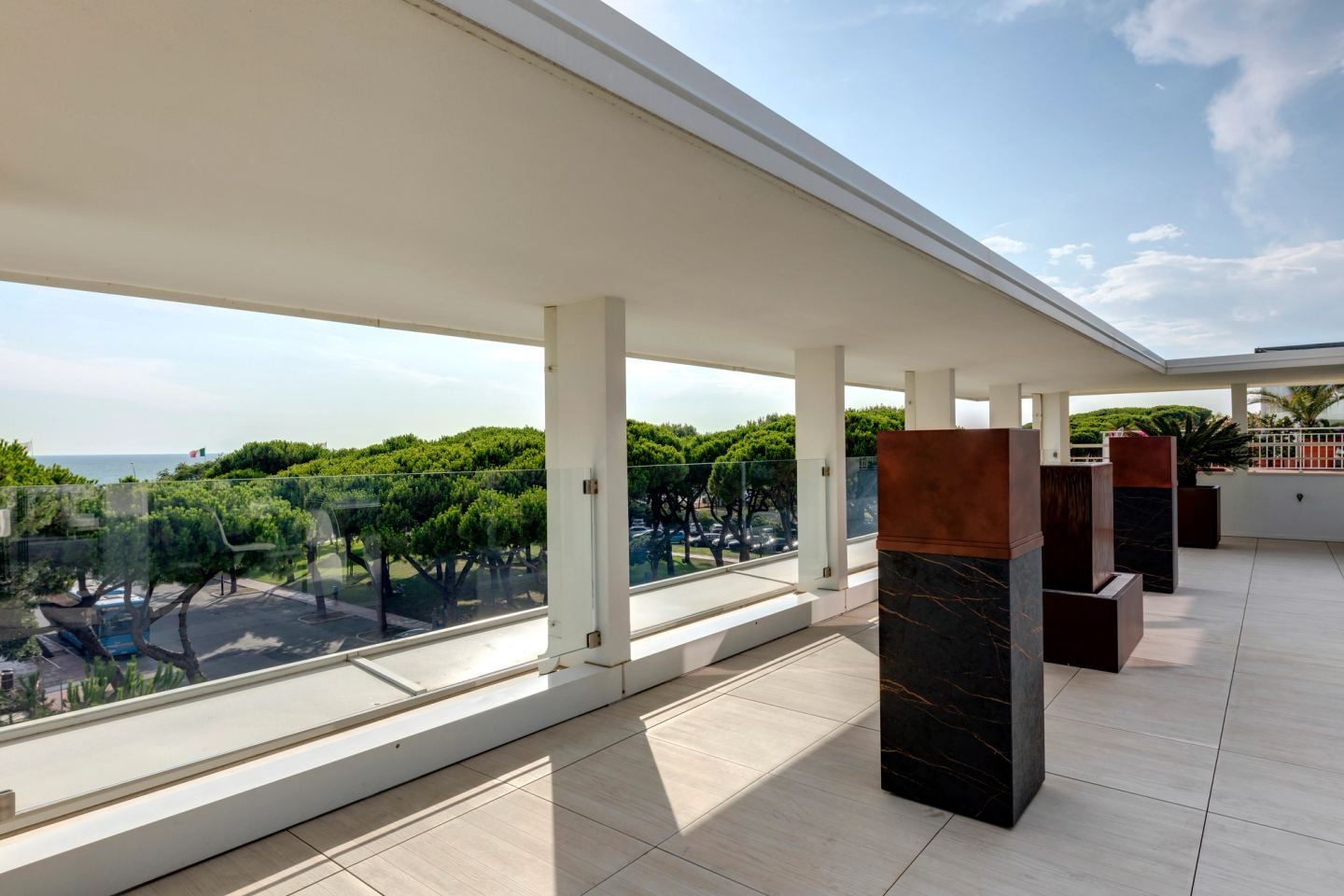 Water column and fire columns down the loggia, pines beyond