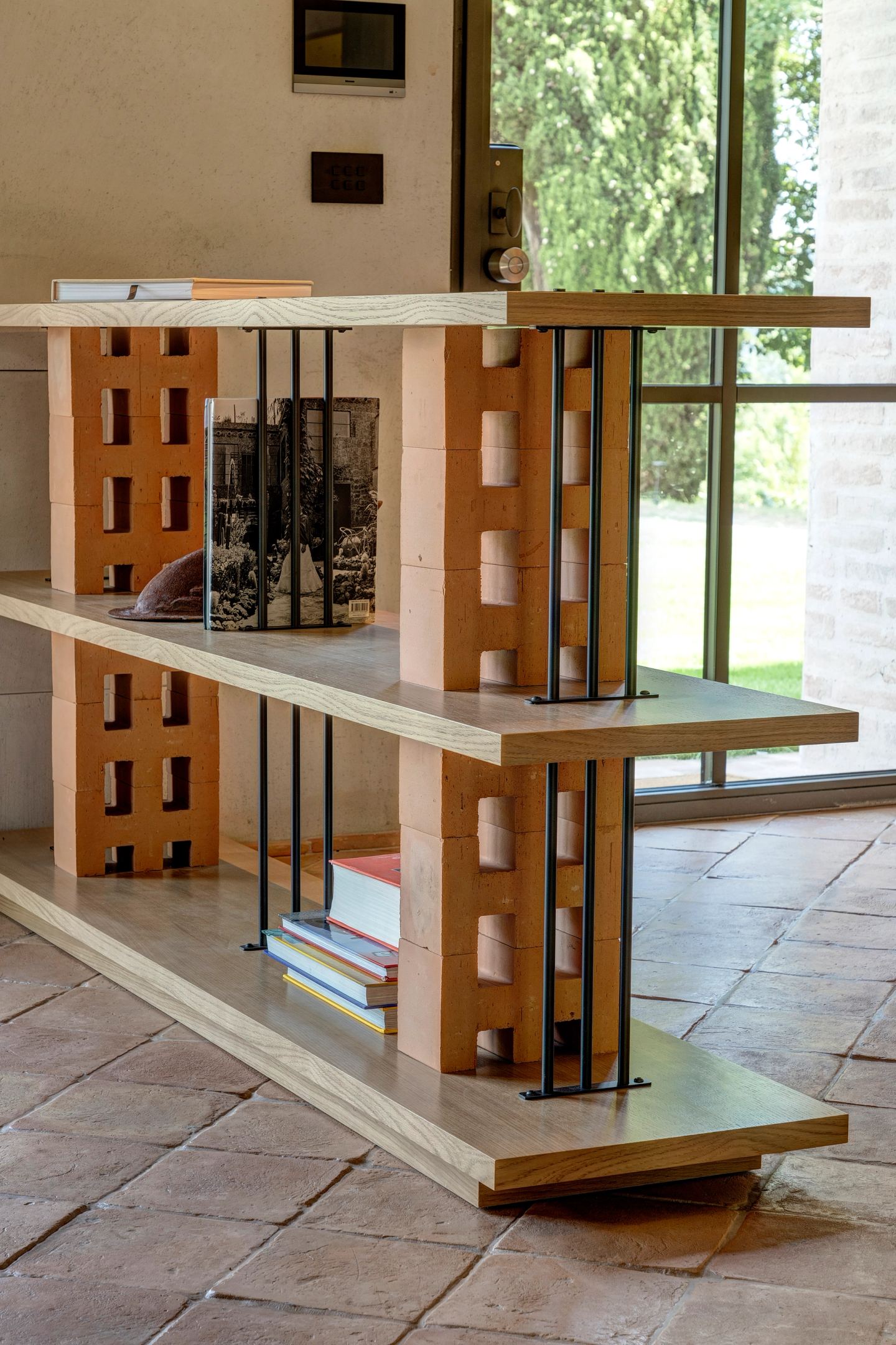 The divider: oak shelves carried on terracotta blocks