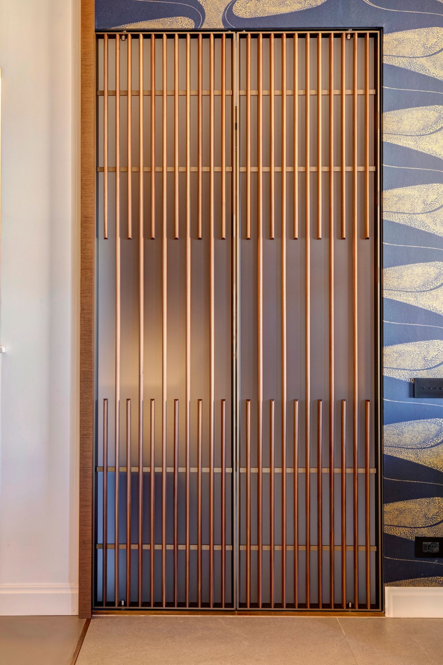 The slatted screen closed, a wall of vertical timber