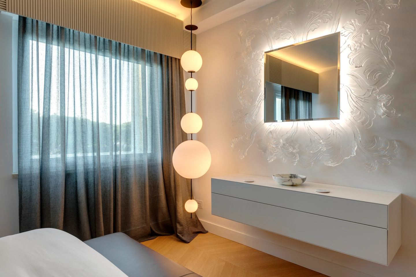 Backlit mirror on the moulded plaster wall above the console