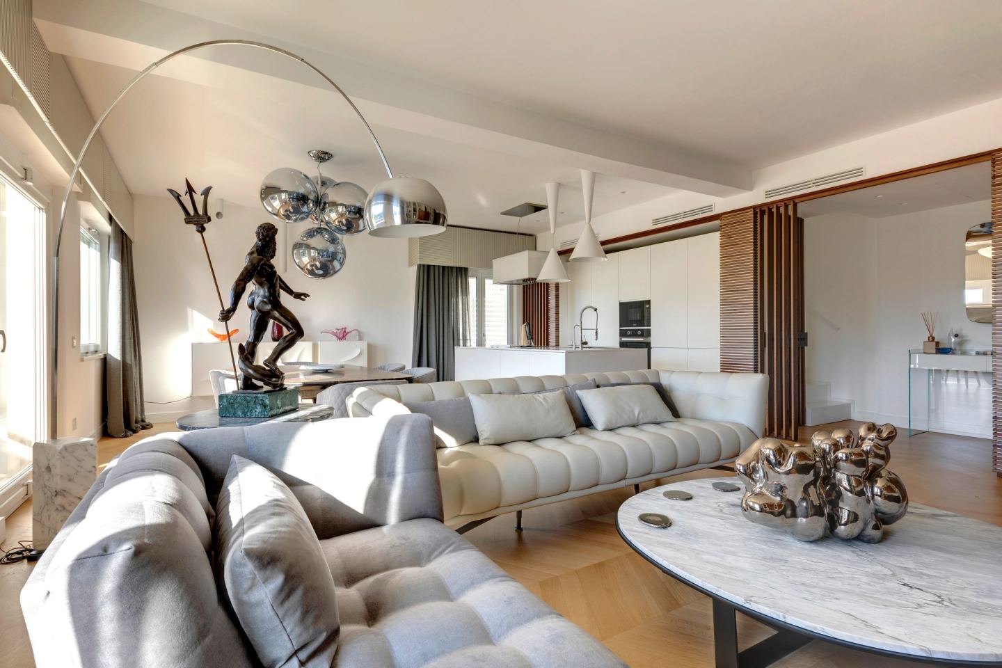 Living room from the far corner, arc lamp reaching over the seating