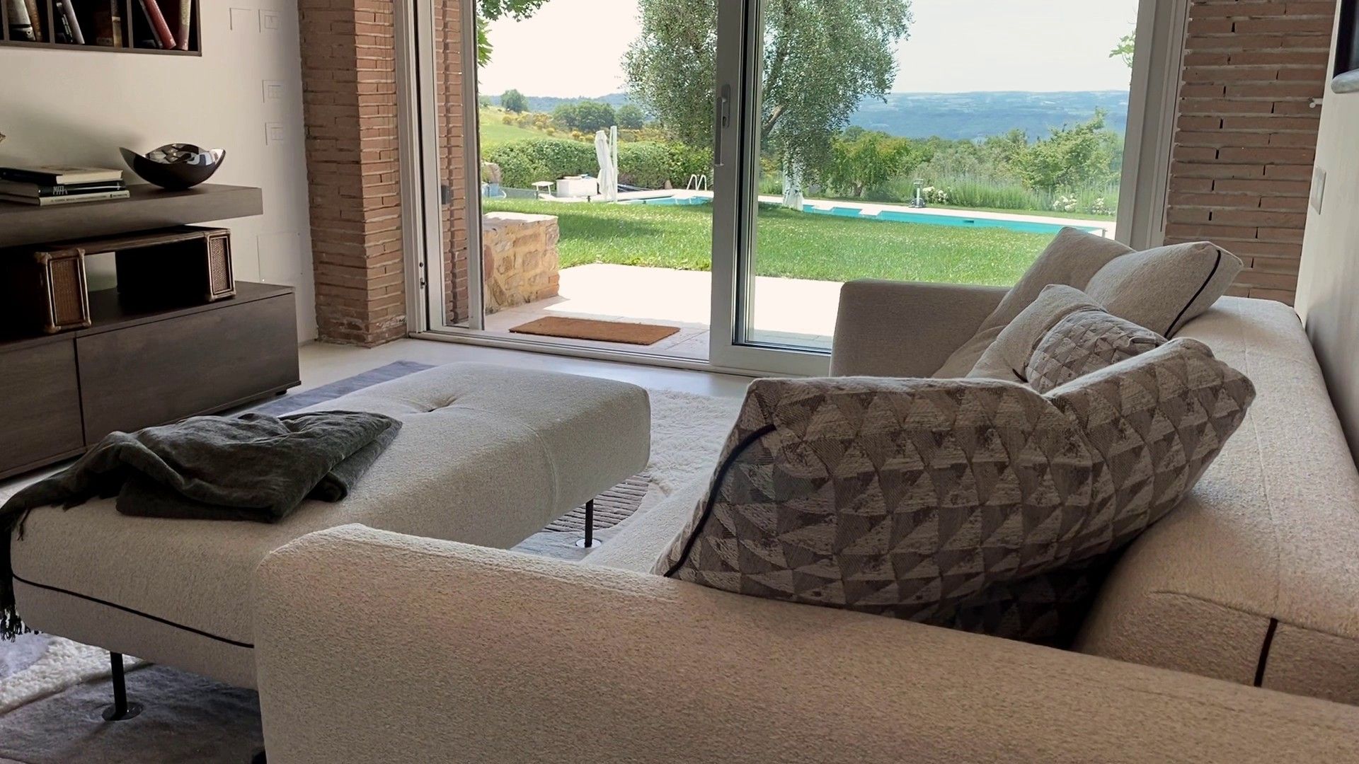 The pale Shifu sofa and bench in the third living room, the garden beyond