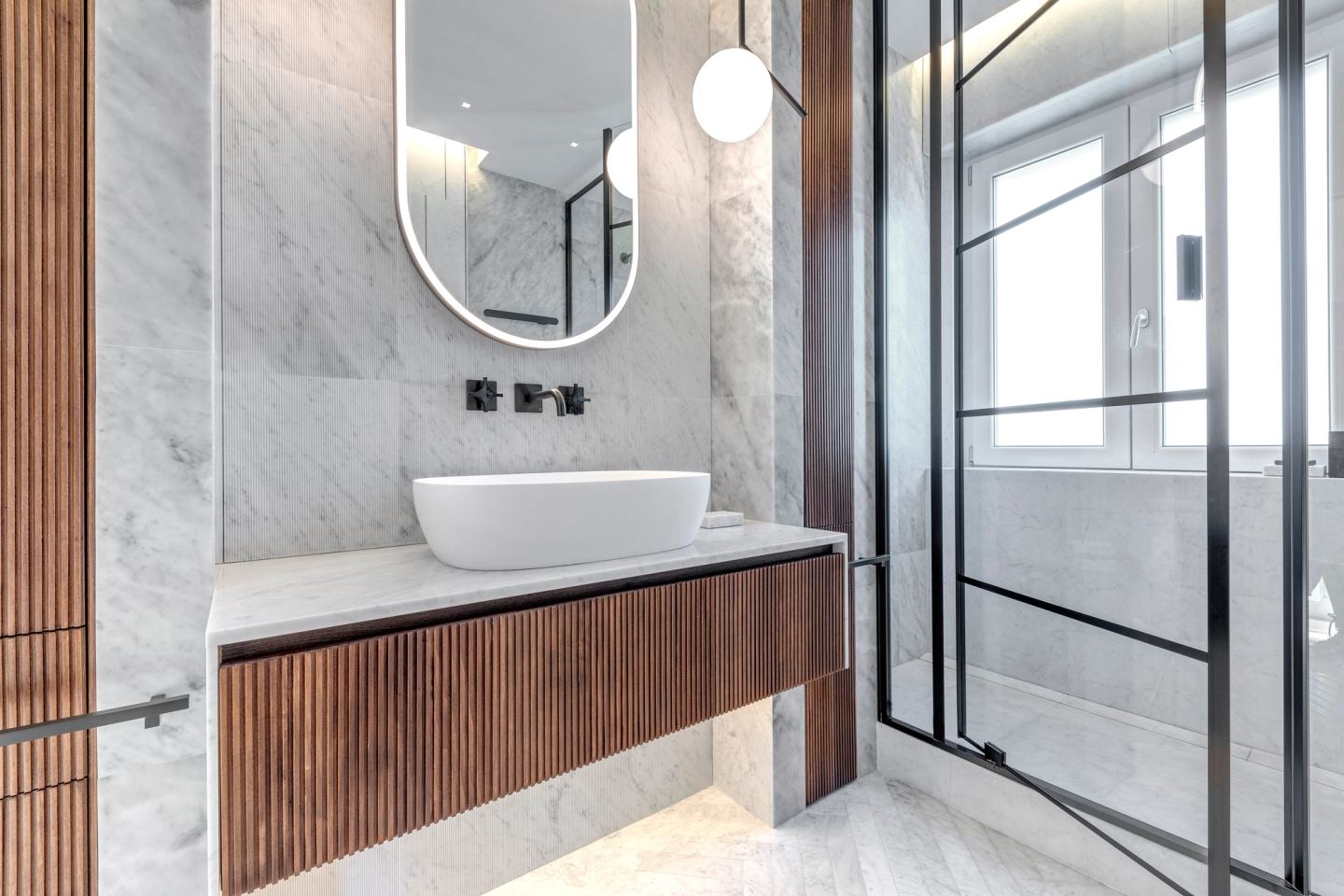 Vanity and mirror with daylight from the window beyond