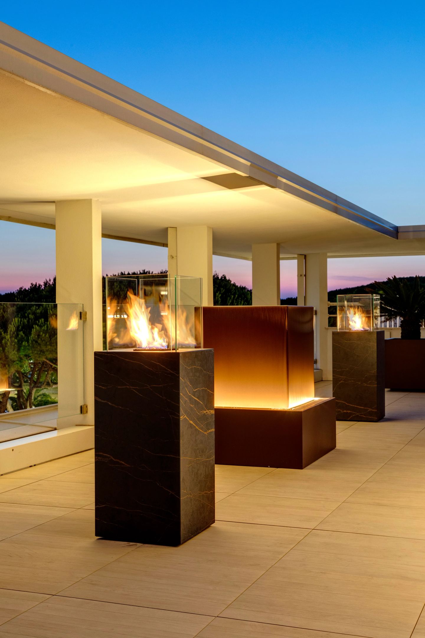 A fire column against the dusk sky, the water column behind