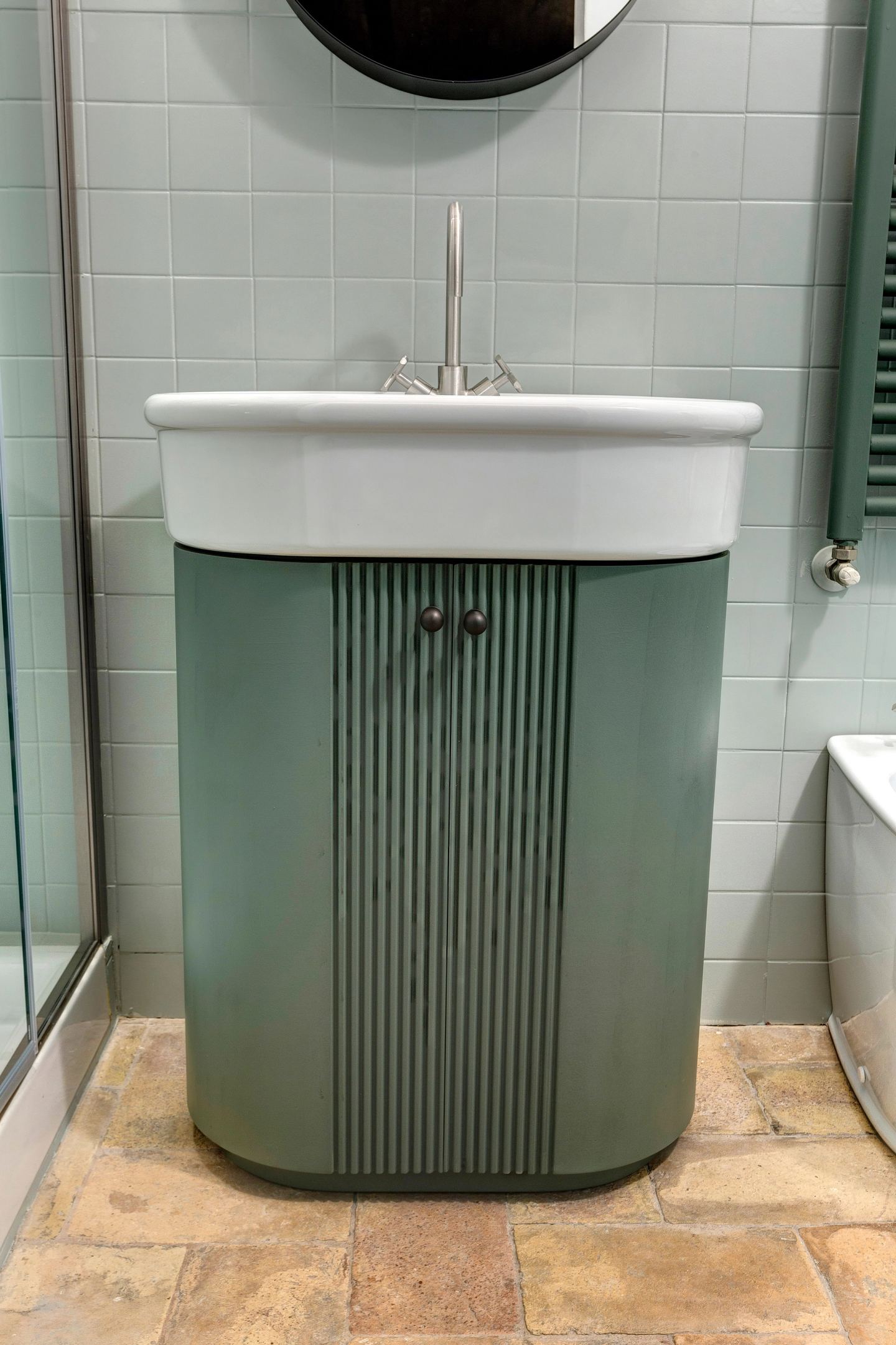 The green fluted cabinet under the basin