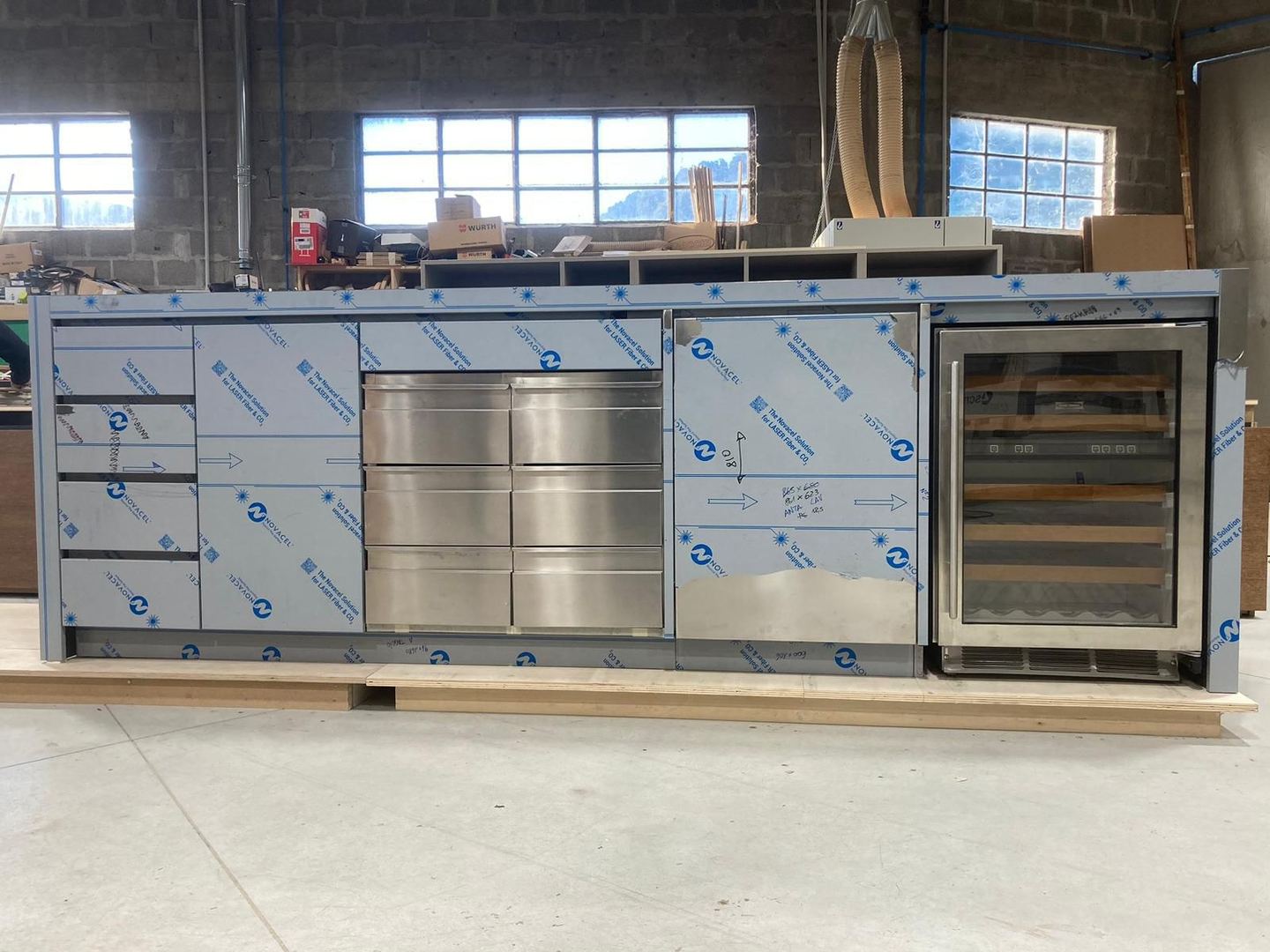 The kitchen island complete in the workshop, still in its film