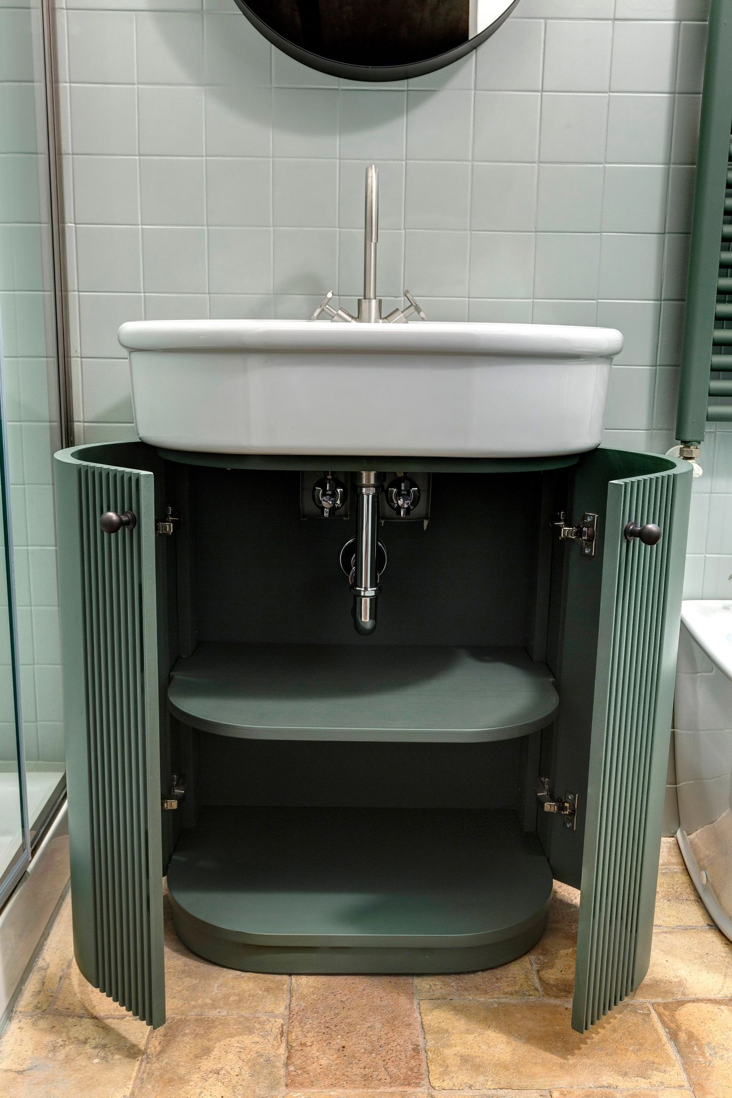 The cabinet open, its curved shelves inside