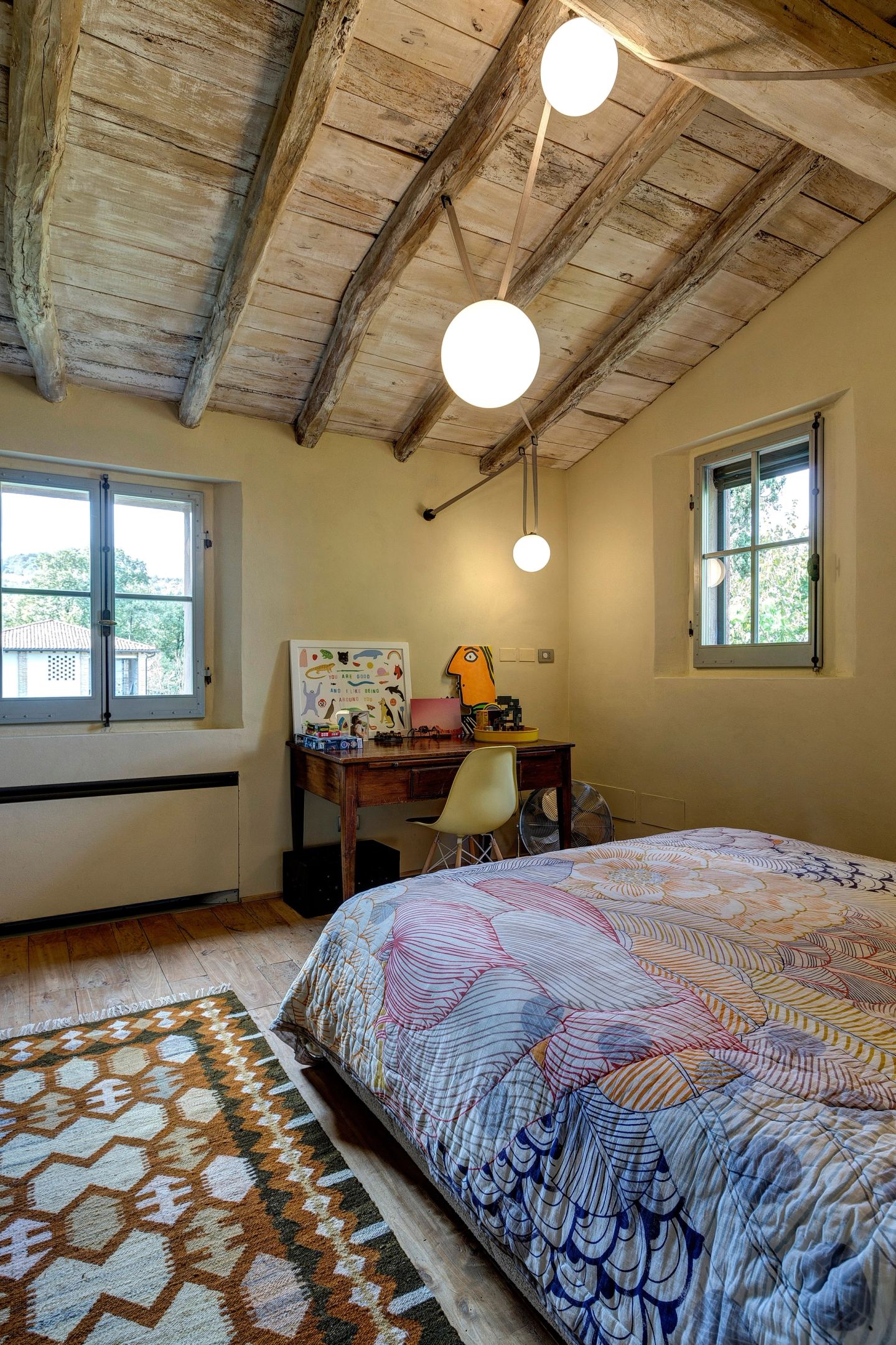 The bed and the pendants under the sloping beams