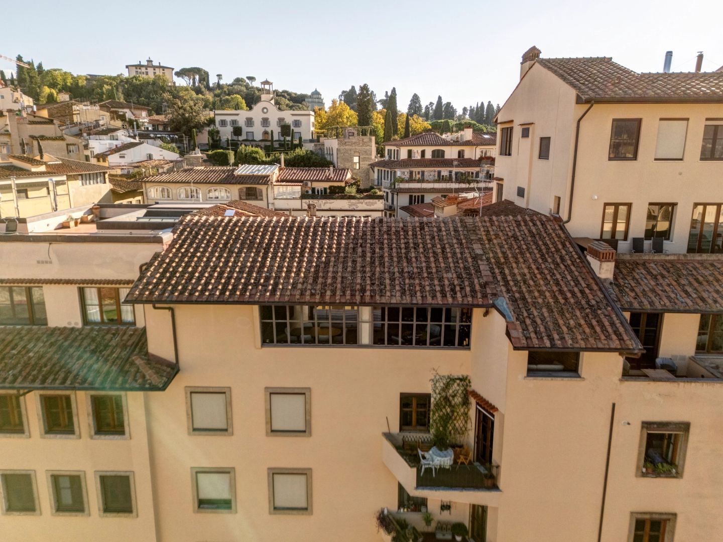 Tiled roofs climbing toward the hills