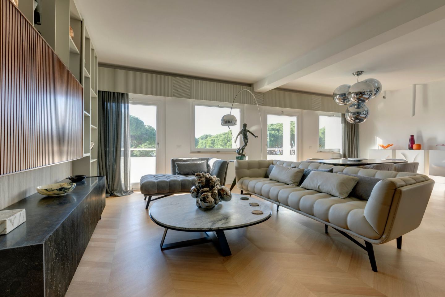 The living room framed by the ribbed walnut screen