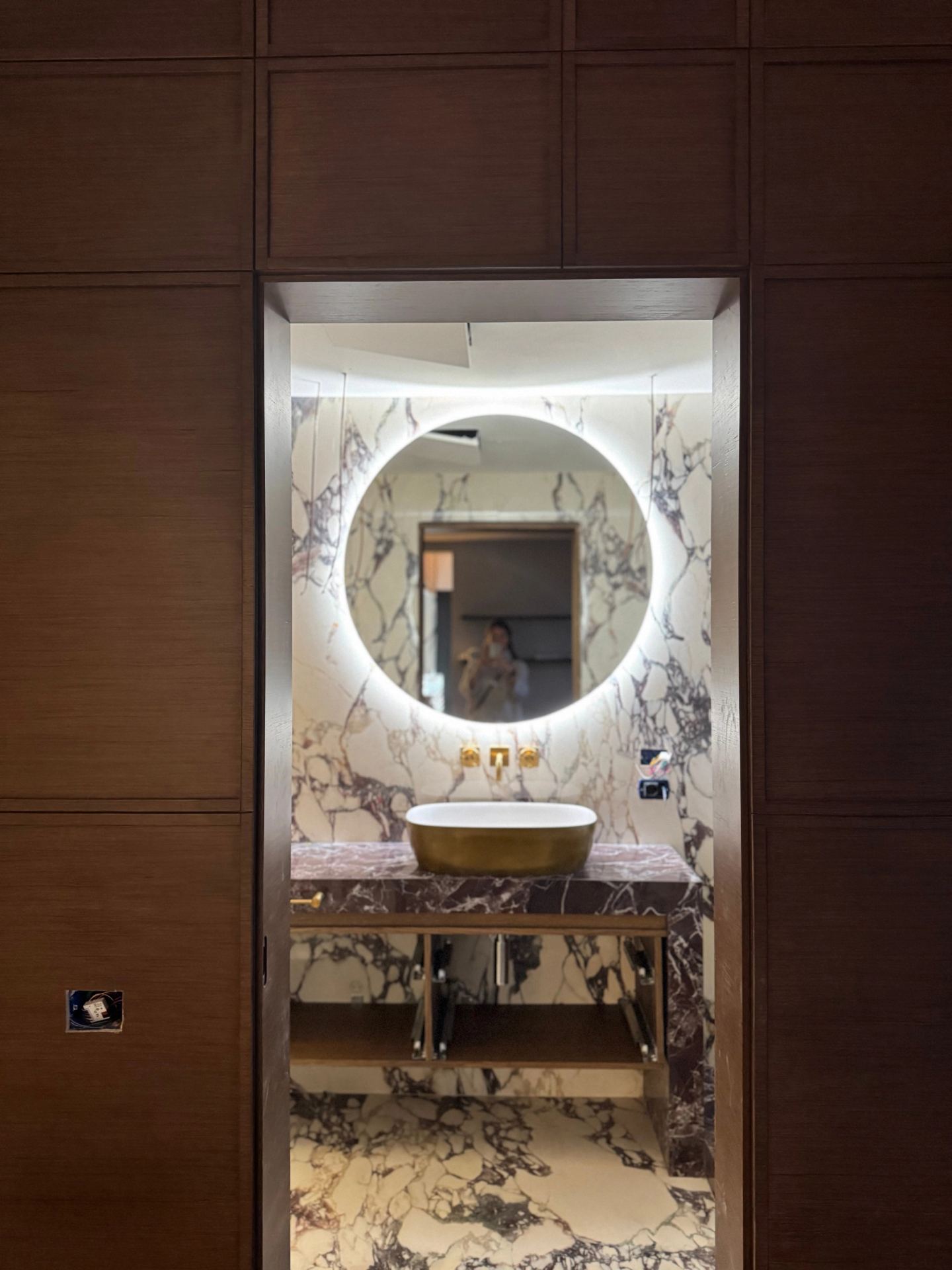 The bathroom seen through a doorway in the wood panelling