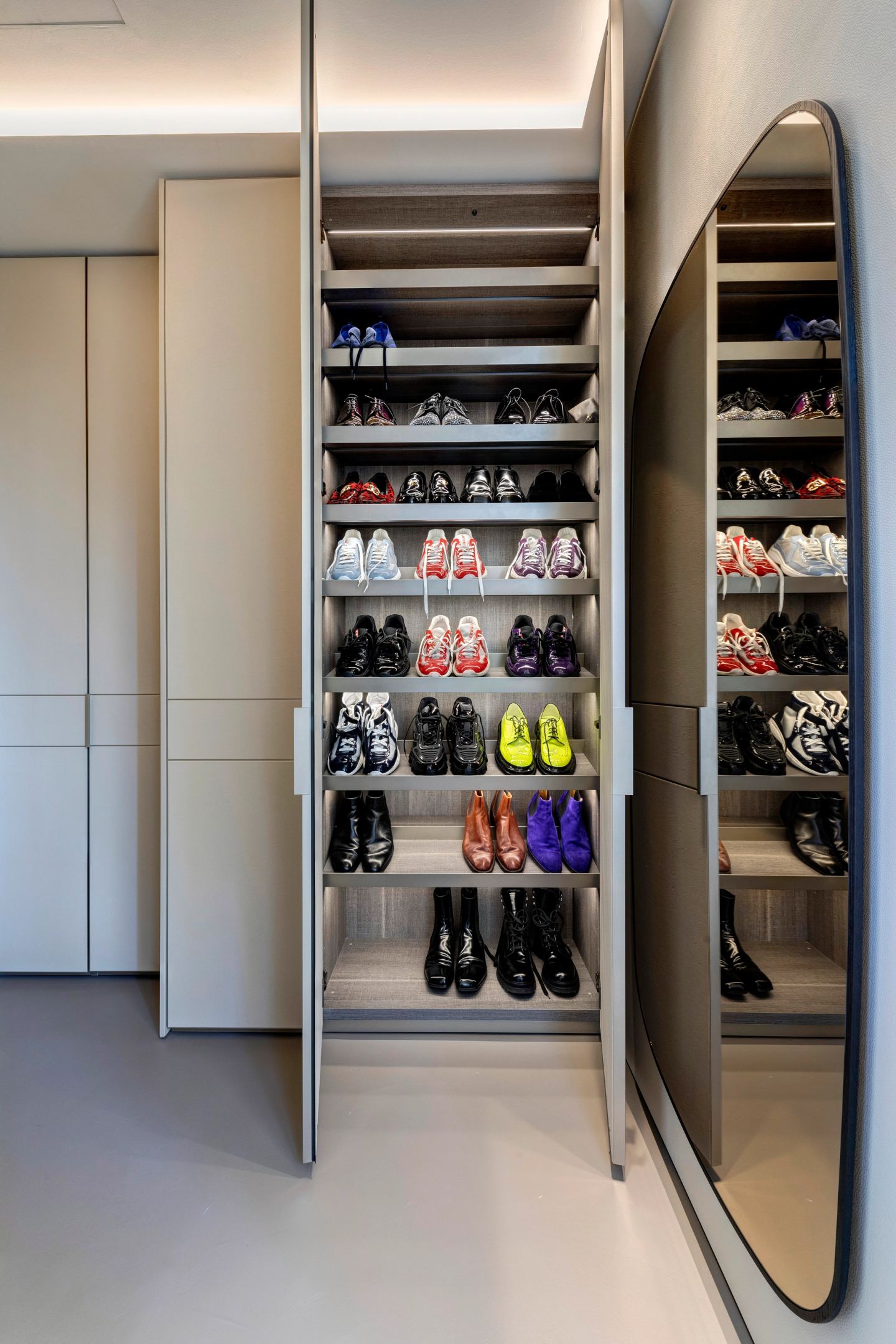The walk-in wardrobe, shoes ranked on the open racks