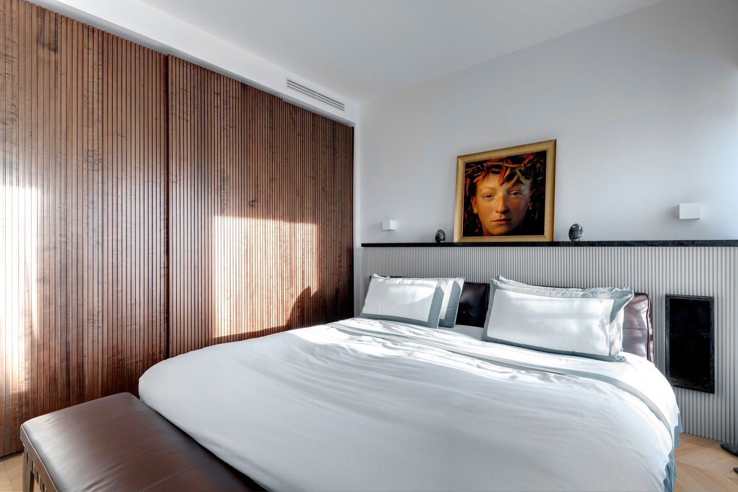 Walnut wardrobe wall running the length of the room