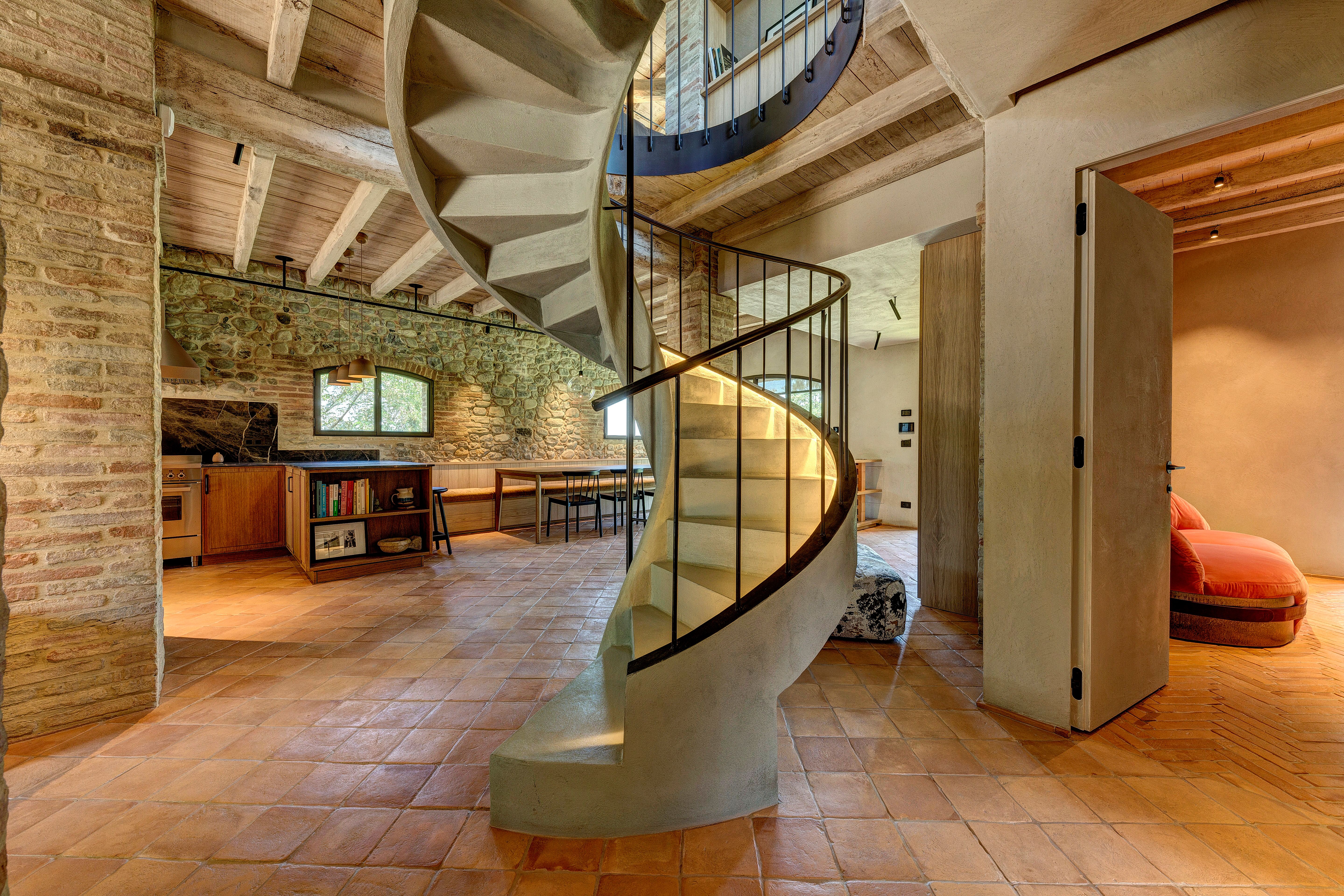 The full turn of the stair on the terracotta floor