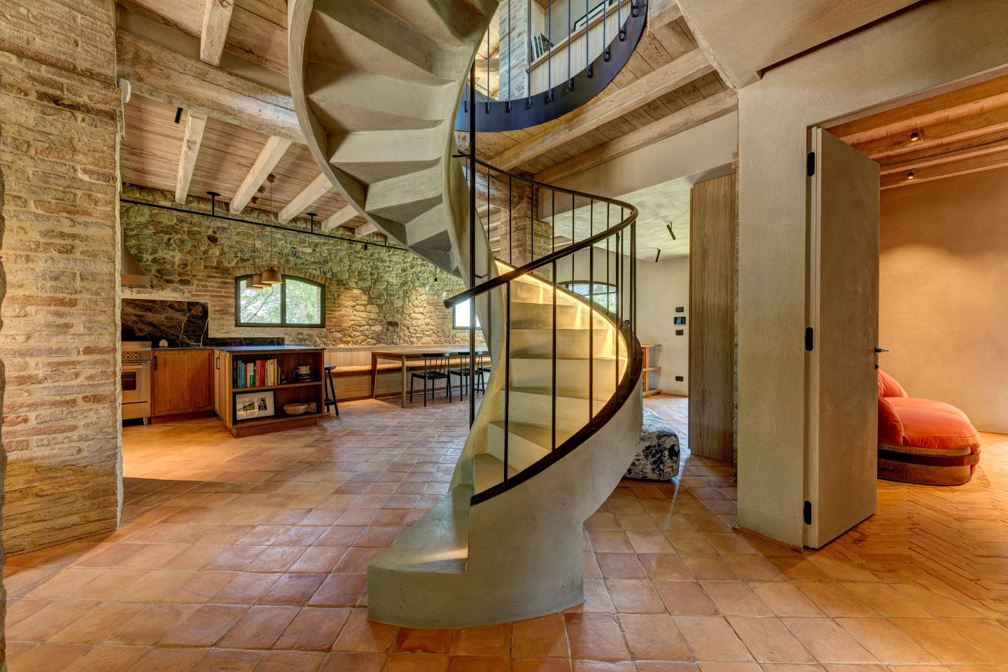 The full turn of the stair on the terracotta floor
