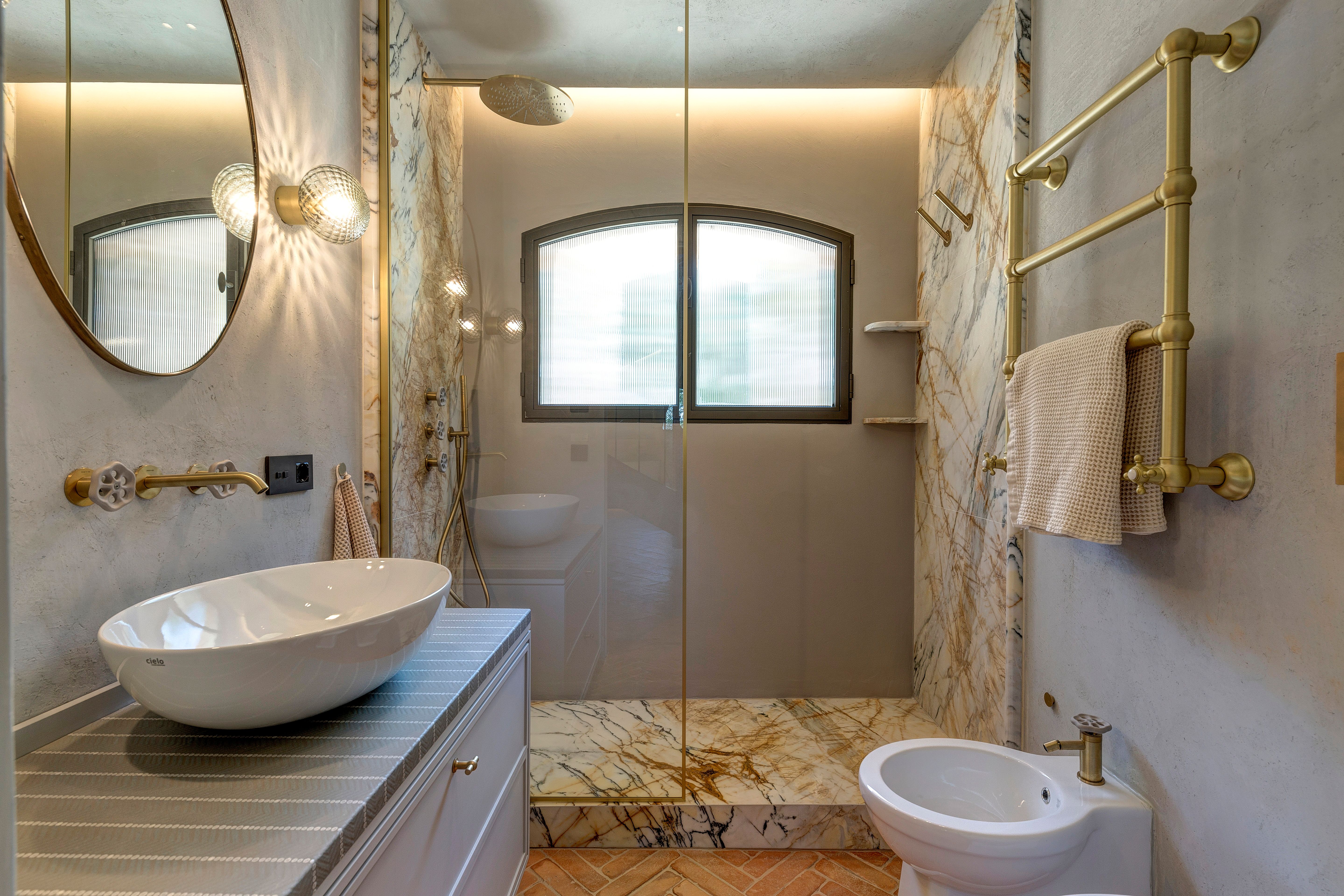 The basin, the shower behind glass, the bidet