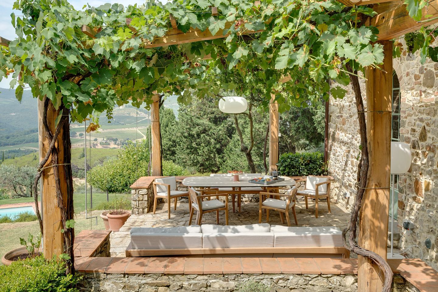 Table and daybed under the vines